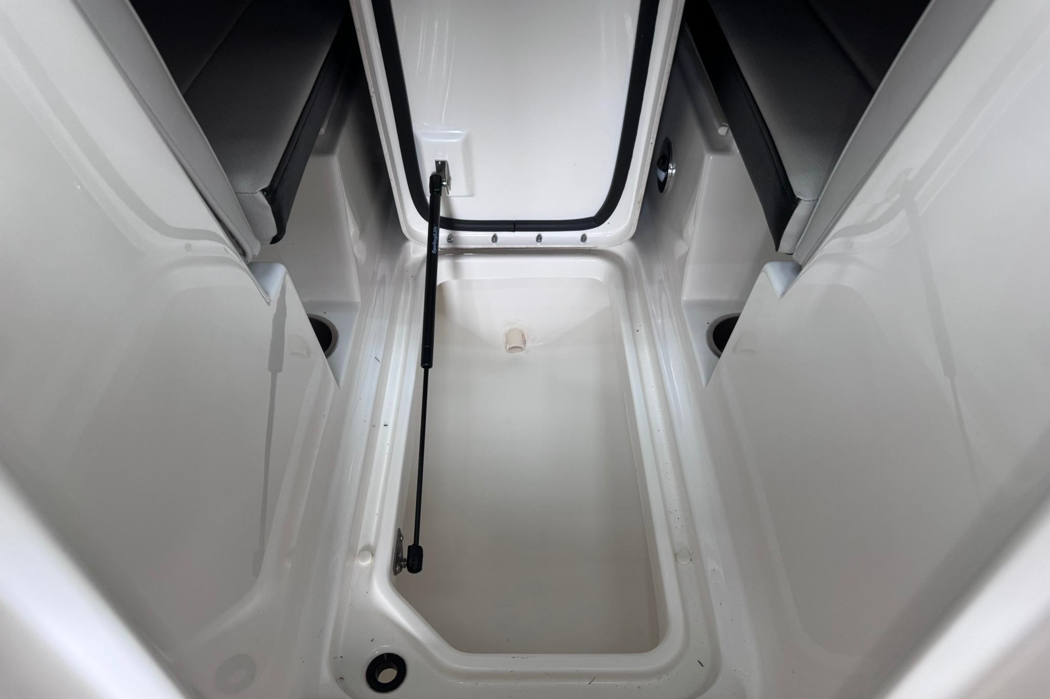 2021 Sea Ray SPX 230 boat storage compartment, open and empty.