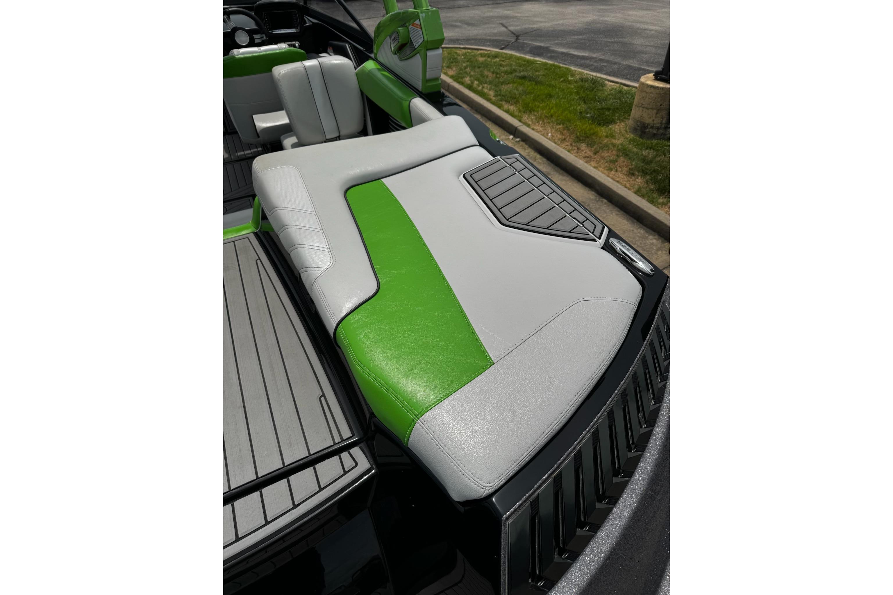 2014 Nautique Super Air Nautique G21 boat interior with green and gray seating.