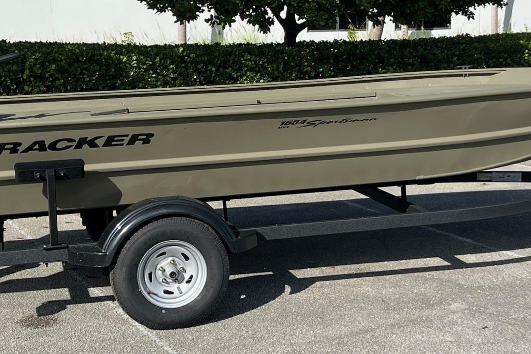 2026 Tracker Grizzly 1654 T Sportsman boat on trailer, parked outdoors.