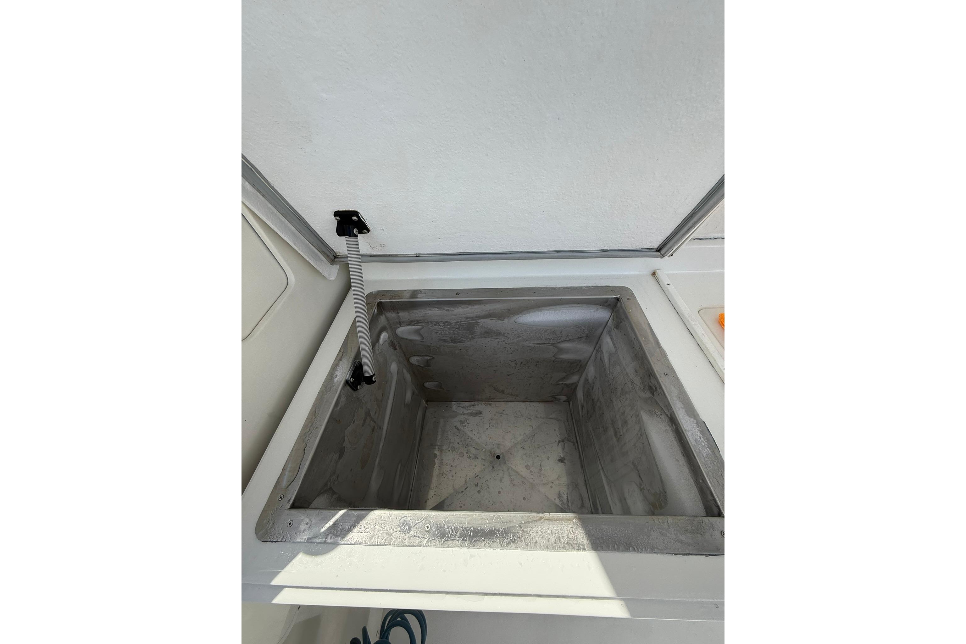 Open storage compartment on 1988 Bertram 43 Flybridge boat.