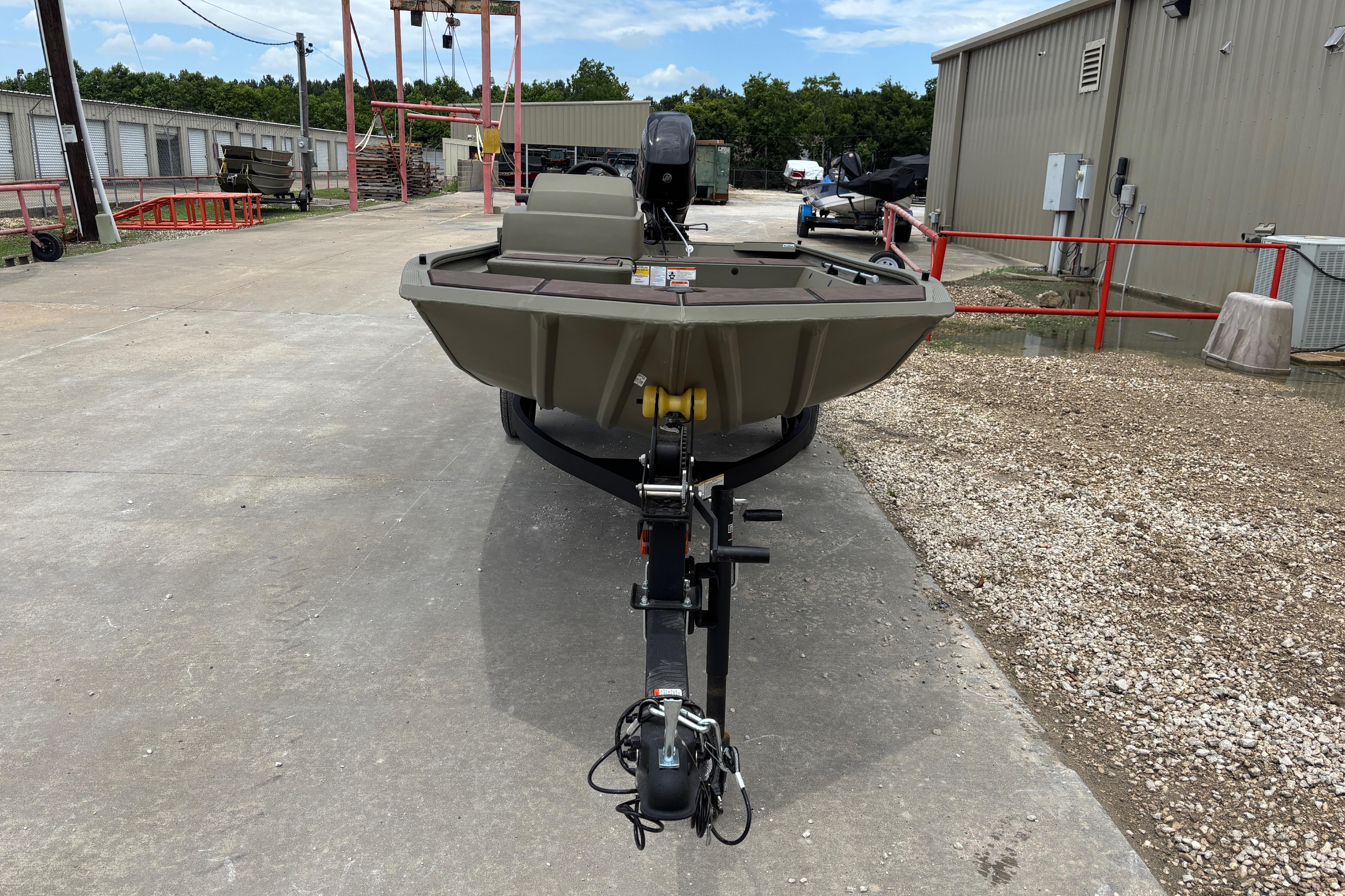 2026 Tracker Grizzly 1648 SC boat on trailer in outdoor storage area.