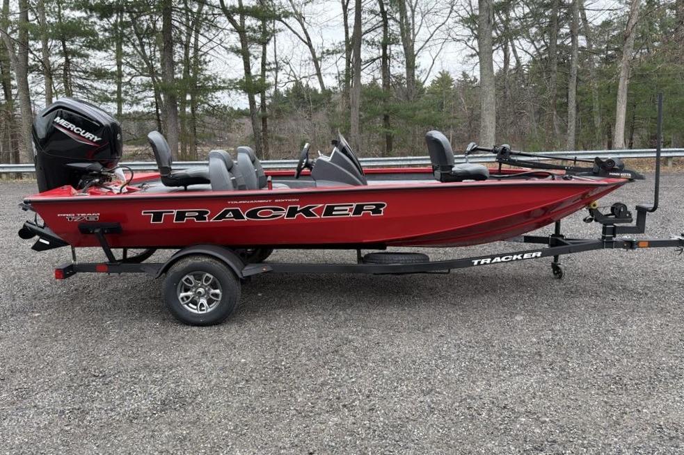 2026 Tracker Pro Team 175 boat on trailer in wooded area.