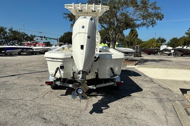 2026 Mako 24 APEX boat with outboard motor in a parking lot.