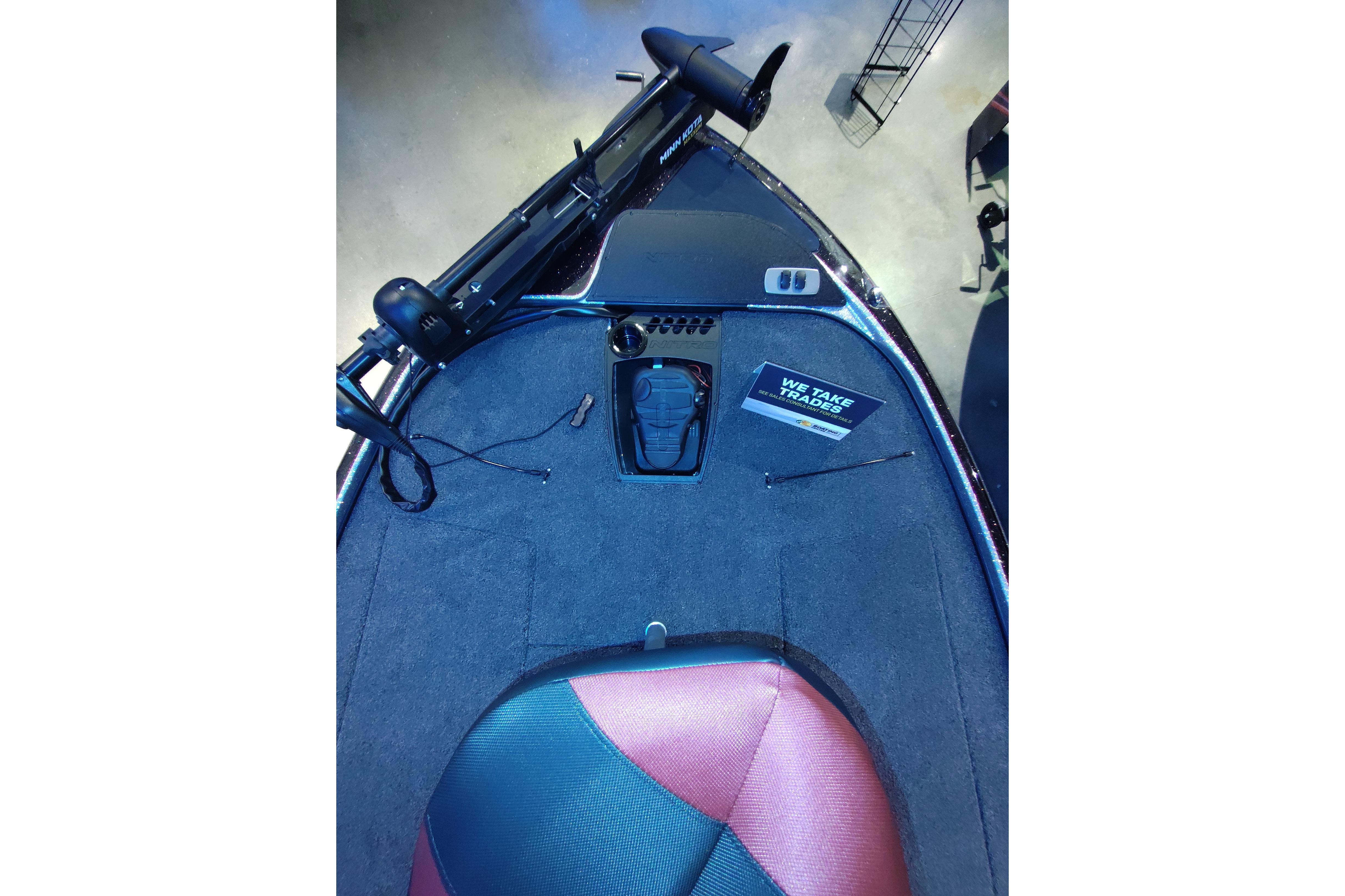 Front deck of a 2026 Nitro Z18 boat with trolling motor and carpeted surface.