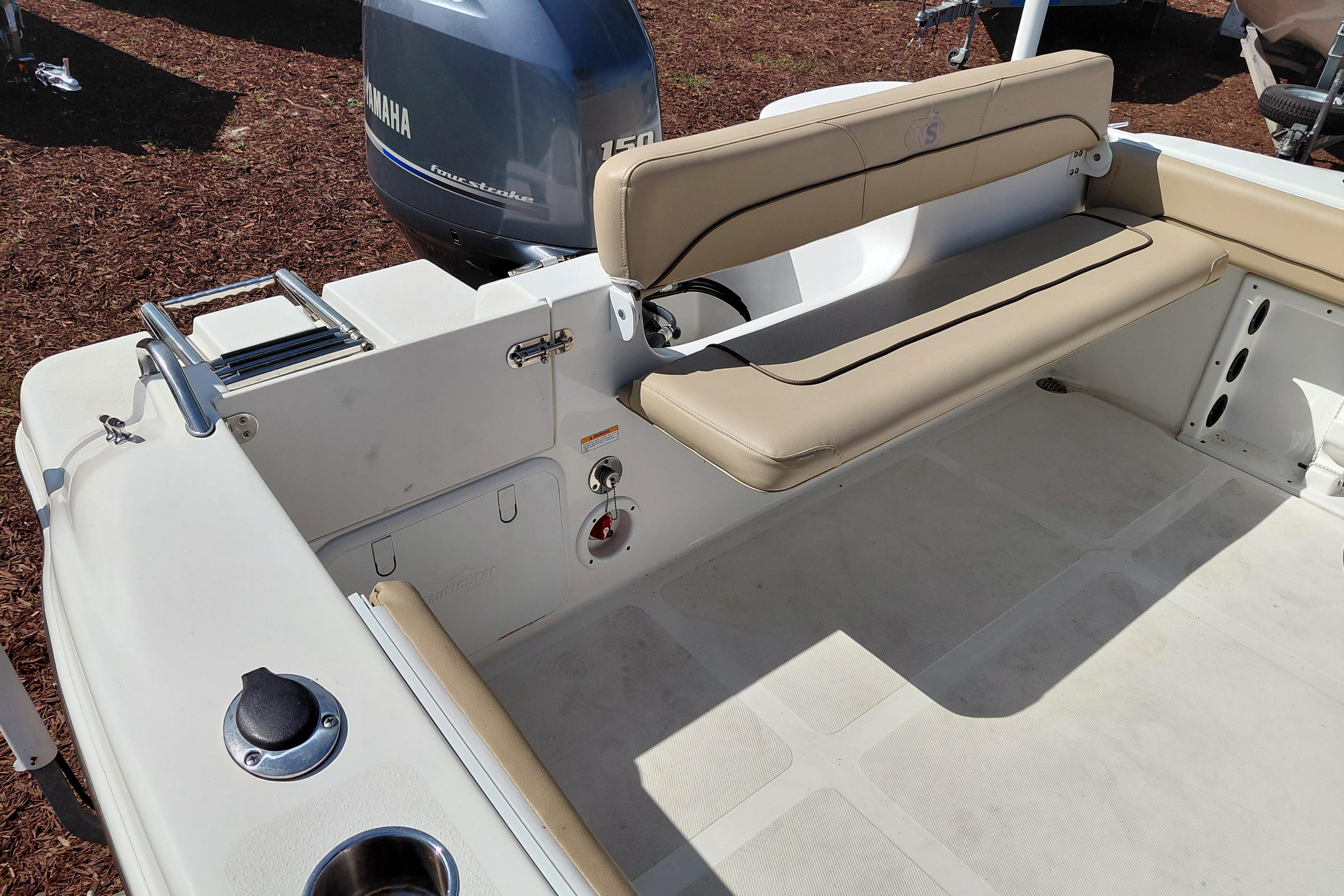 2020 NauticStar 20 XS boat interior with Yamaha engine and beige seating.
