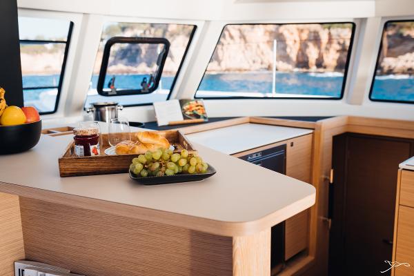 Interior of 2025 Nautitech 44 Open yacht with breakfast setup and ocean view.