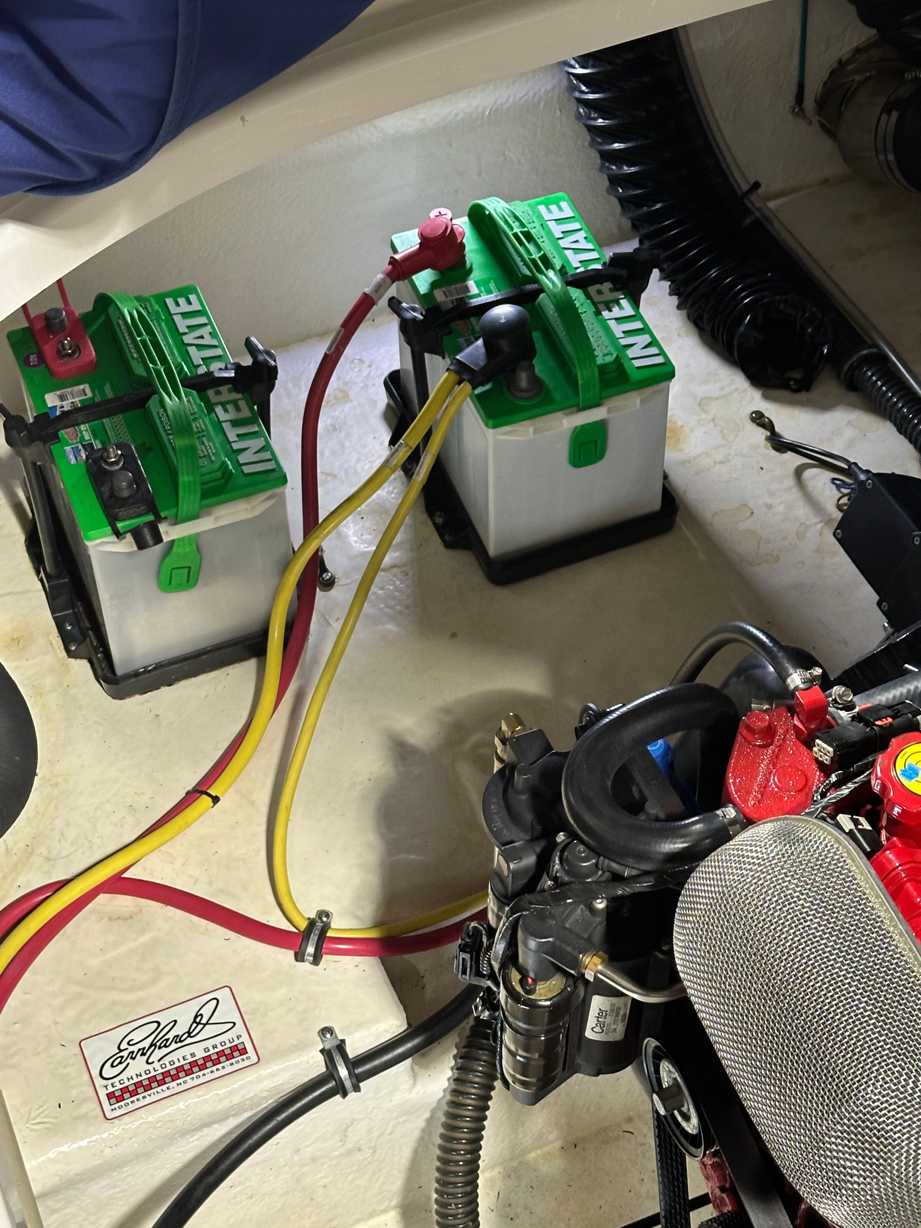 View of a 2011 Chaparral 287 SSX engine compartment with two green batteries.