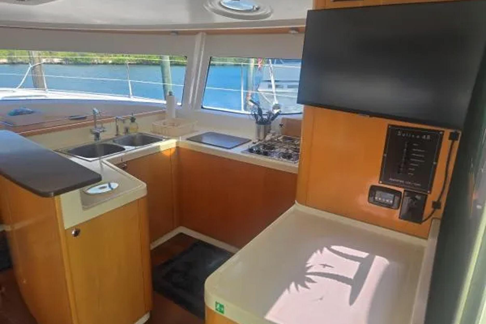 Interior of 2008 Fountaine Pajot Salina 48 catamaran kitchen with modern amenities.