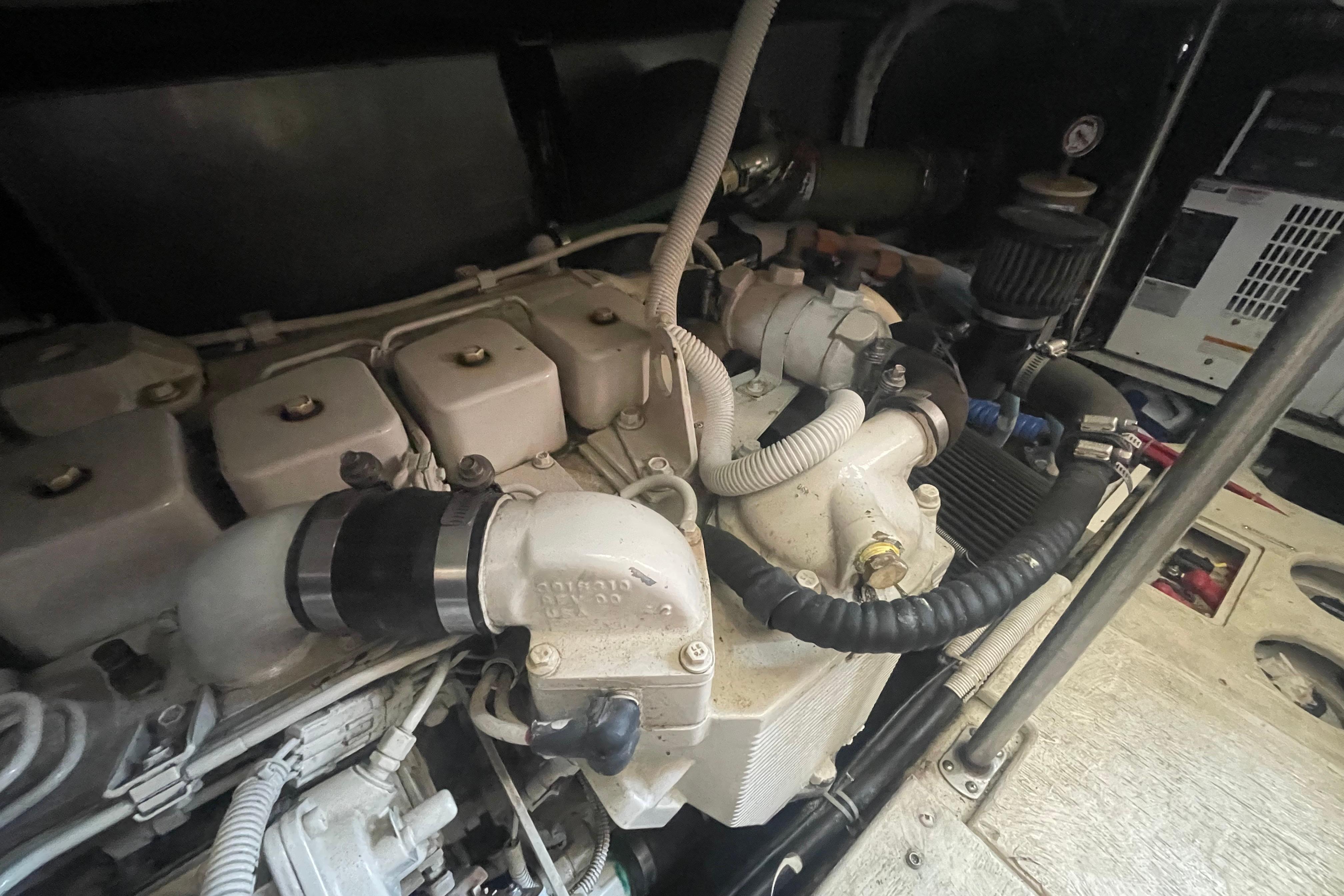Engine compartment of a 2002 Carver 410 Sport Sedan boat, showcasing mechanical components.