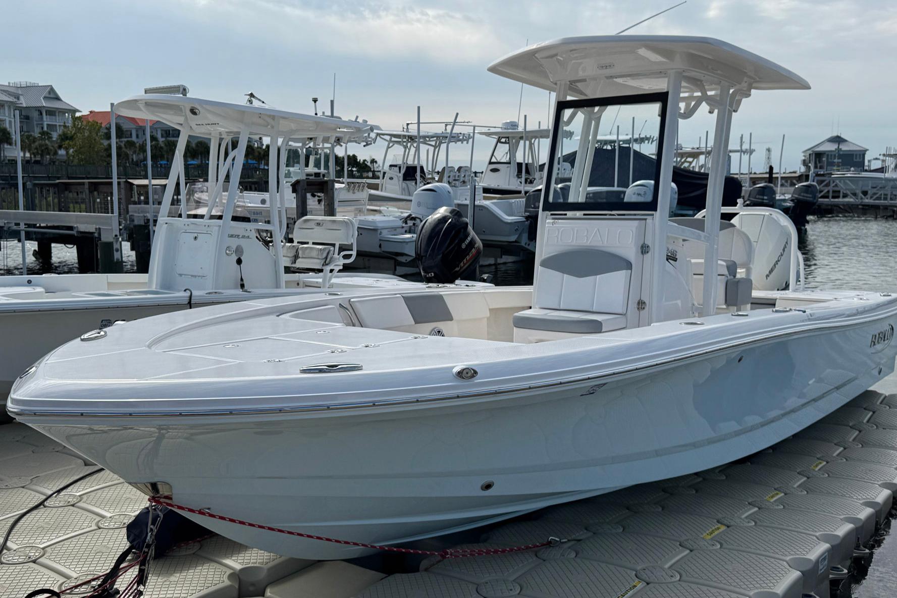 2021 Robalo 246 Cayman boat docked at marina, showcasing sleek design and modern features.