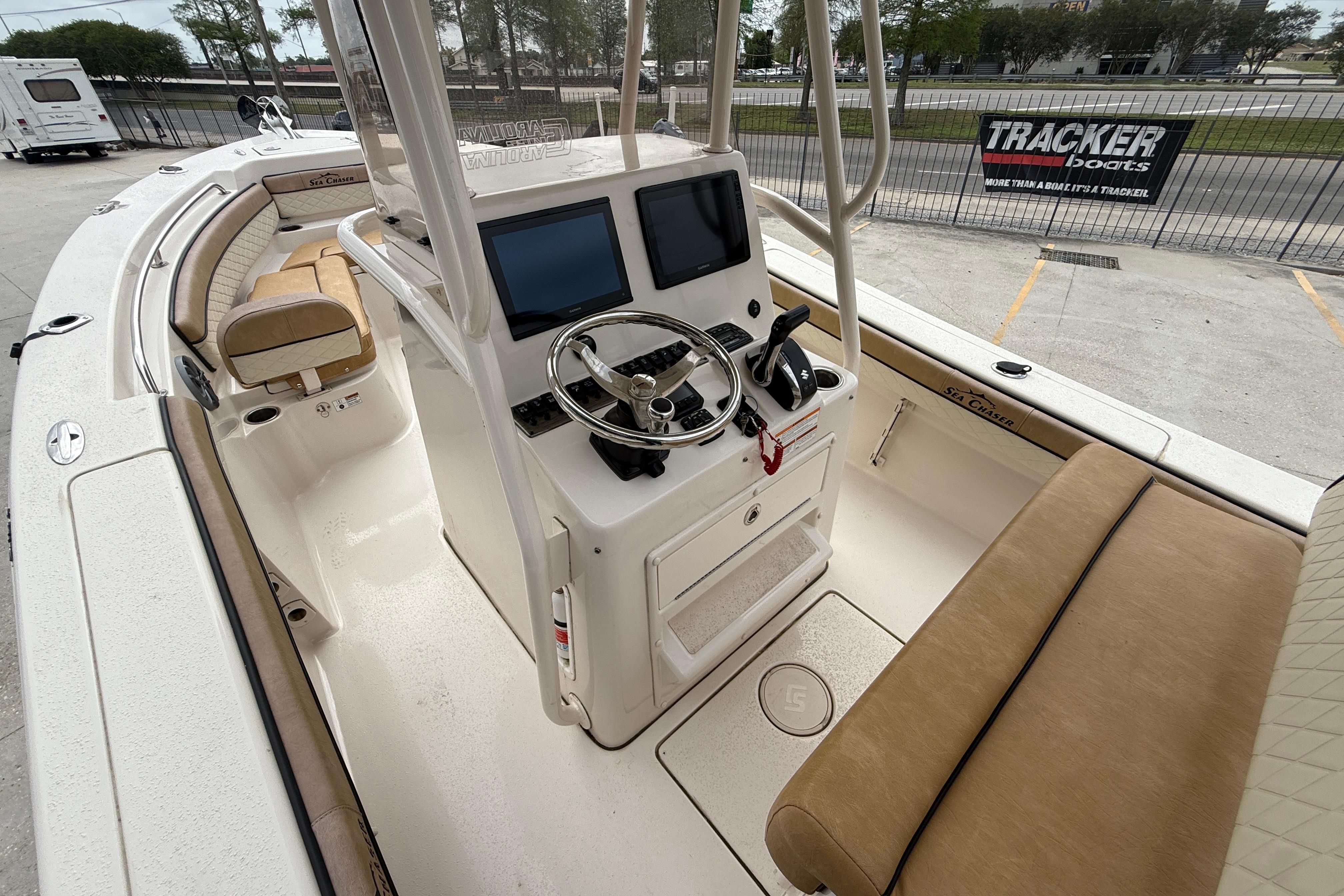 2023 SeaChaser 24 HFC boat interior with dual screens and beige seating.