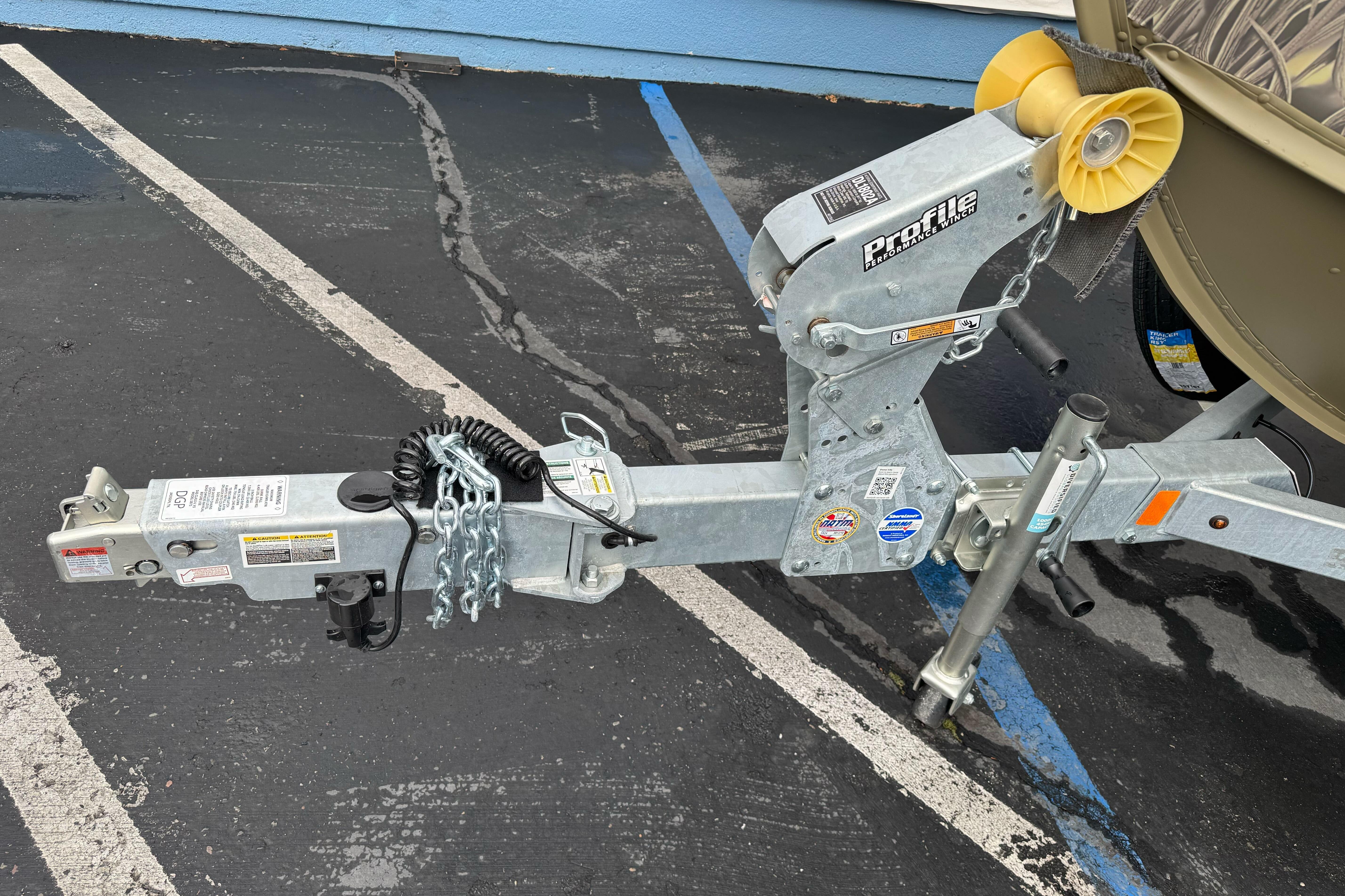 Trailer hitch of 2026 Lund 2075 Alaskan SS boat in parking lot.