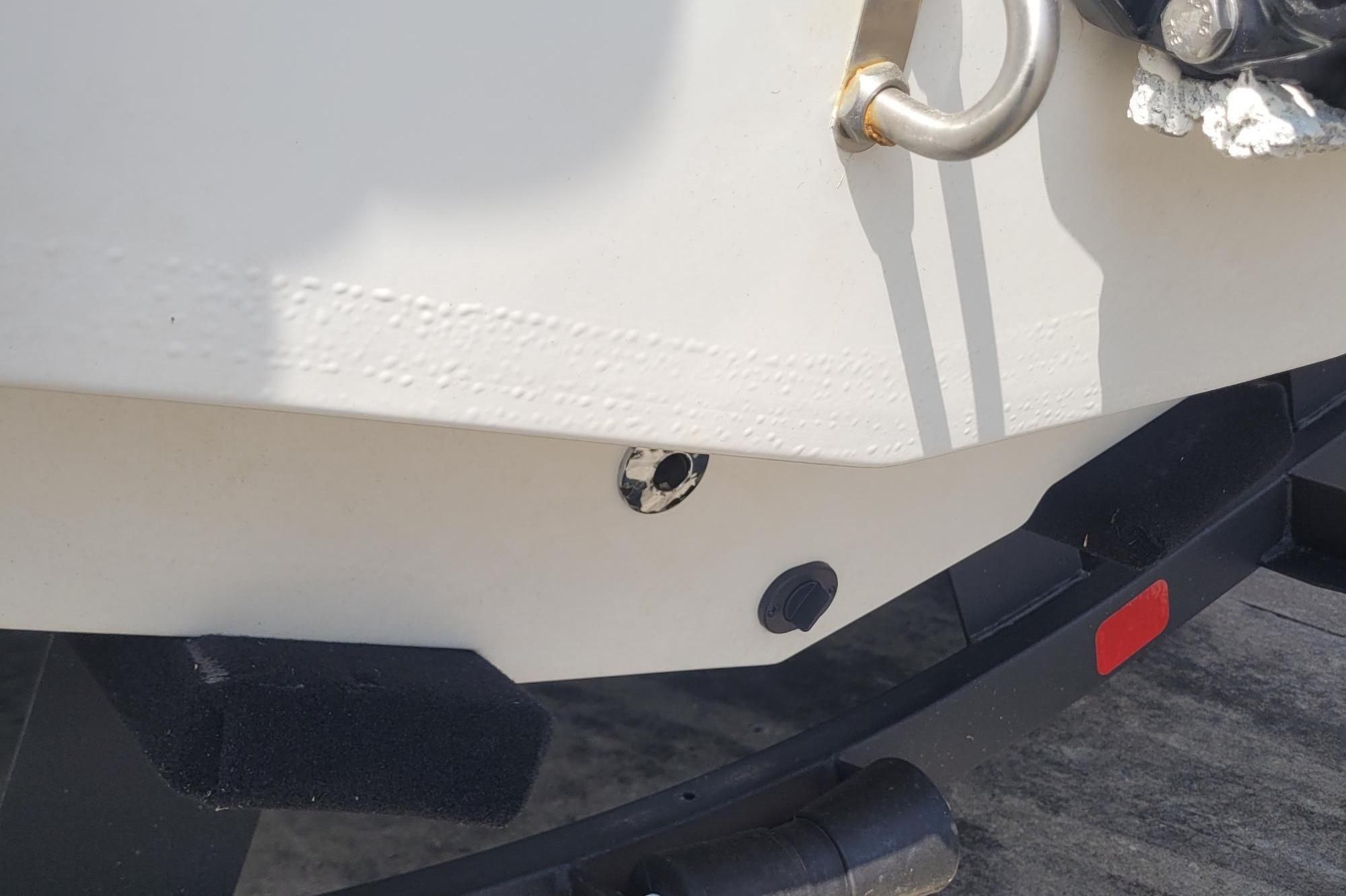 Close-up of a 2024 Tahoe 1950 boat's hull and trailer detail.