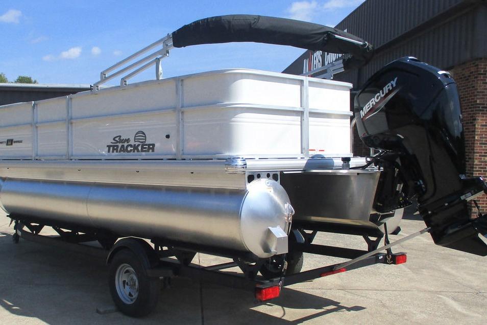 2026 Sun Tracker Party Barge 18 DLX pontoon boat with Mercury outboard motor on trailer.