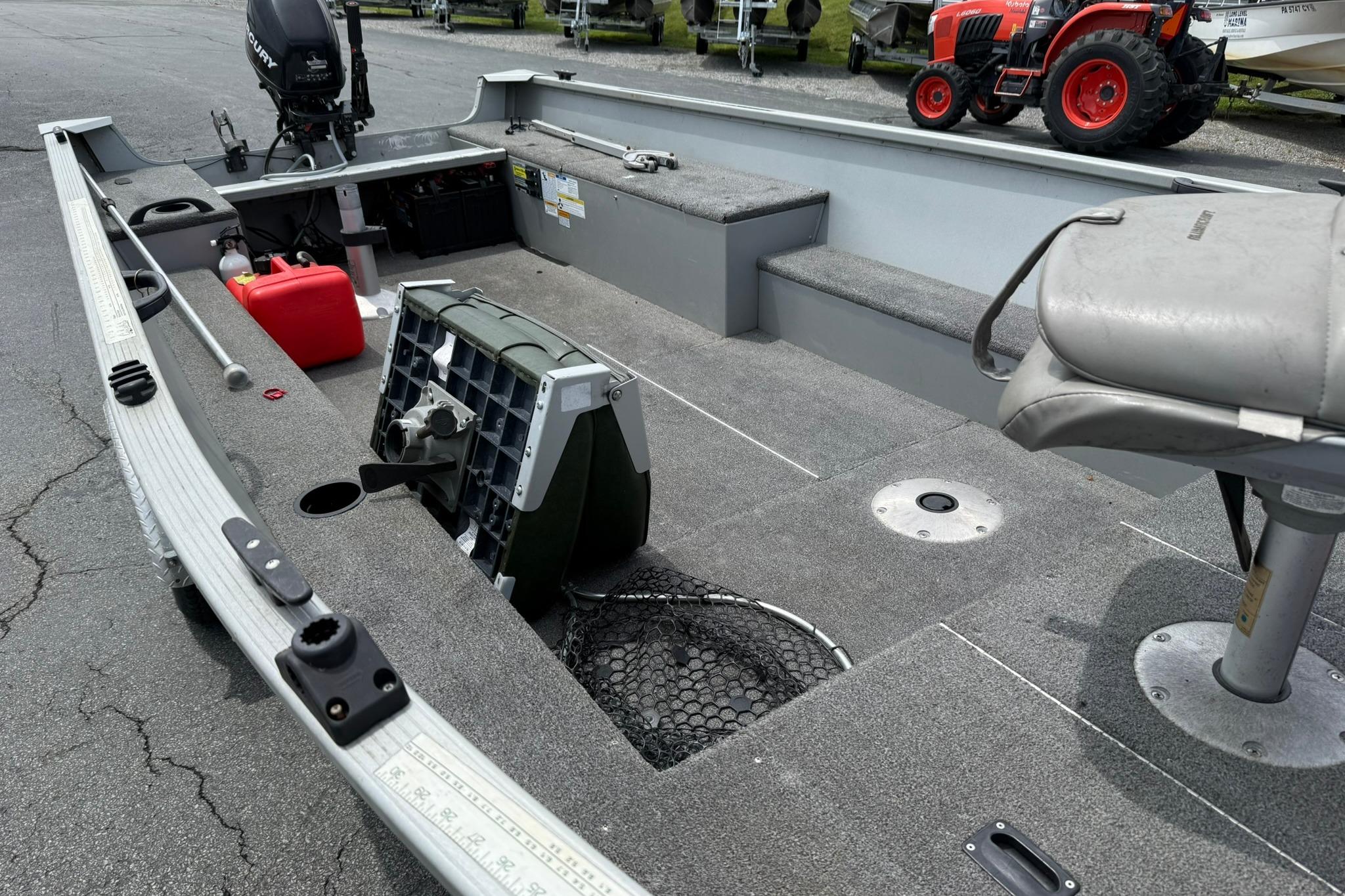 2013 Alumacraft Fisherman 160 Tiller boat with seating, storage, and outboard motor.