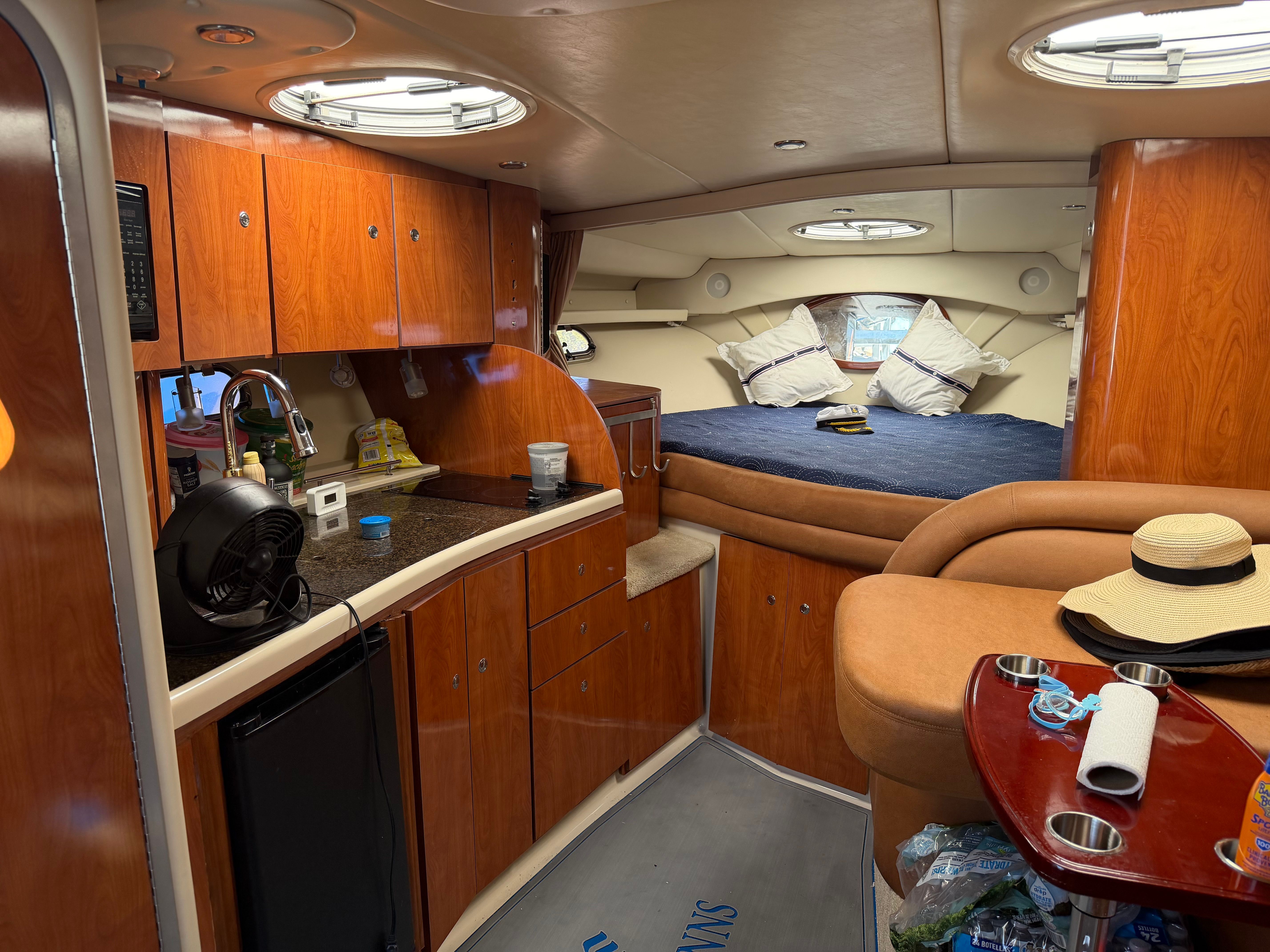 Interior of a 2006 Four Winns 328 Vista yacht with kitchen and sleeping area.