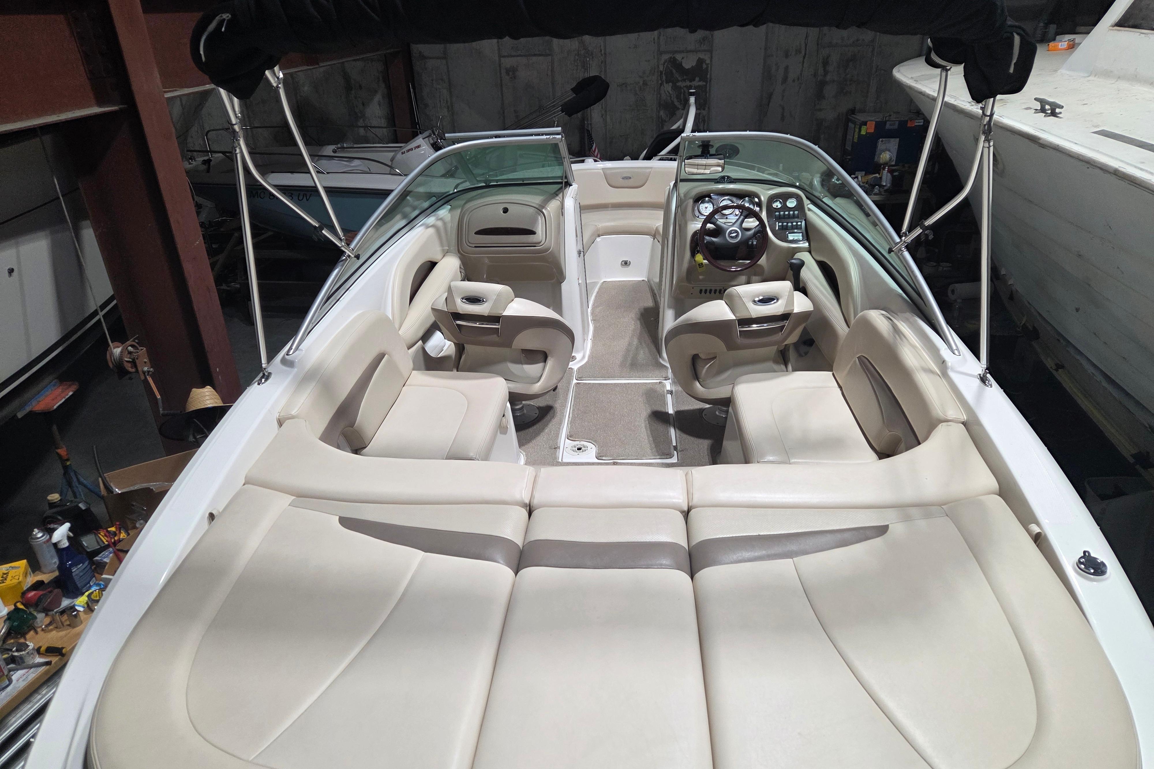 2006 Chaparral 236 SSi boat interior with beige seating and steering console.