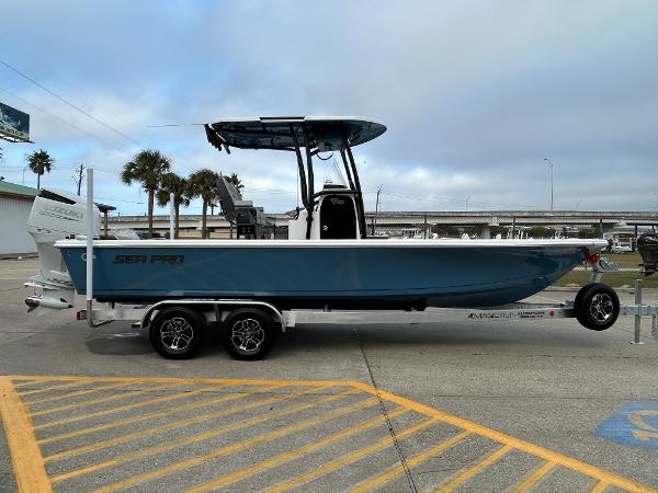 2024 Sea Pro 250 DLX boat on trailer, parked outdoors.
