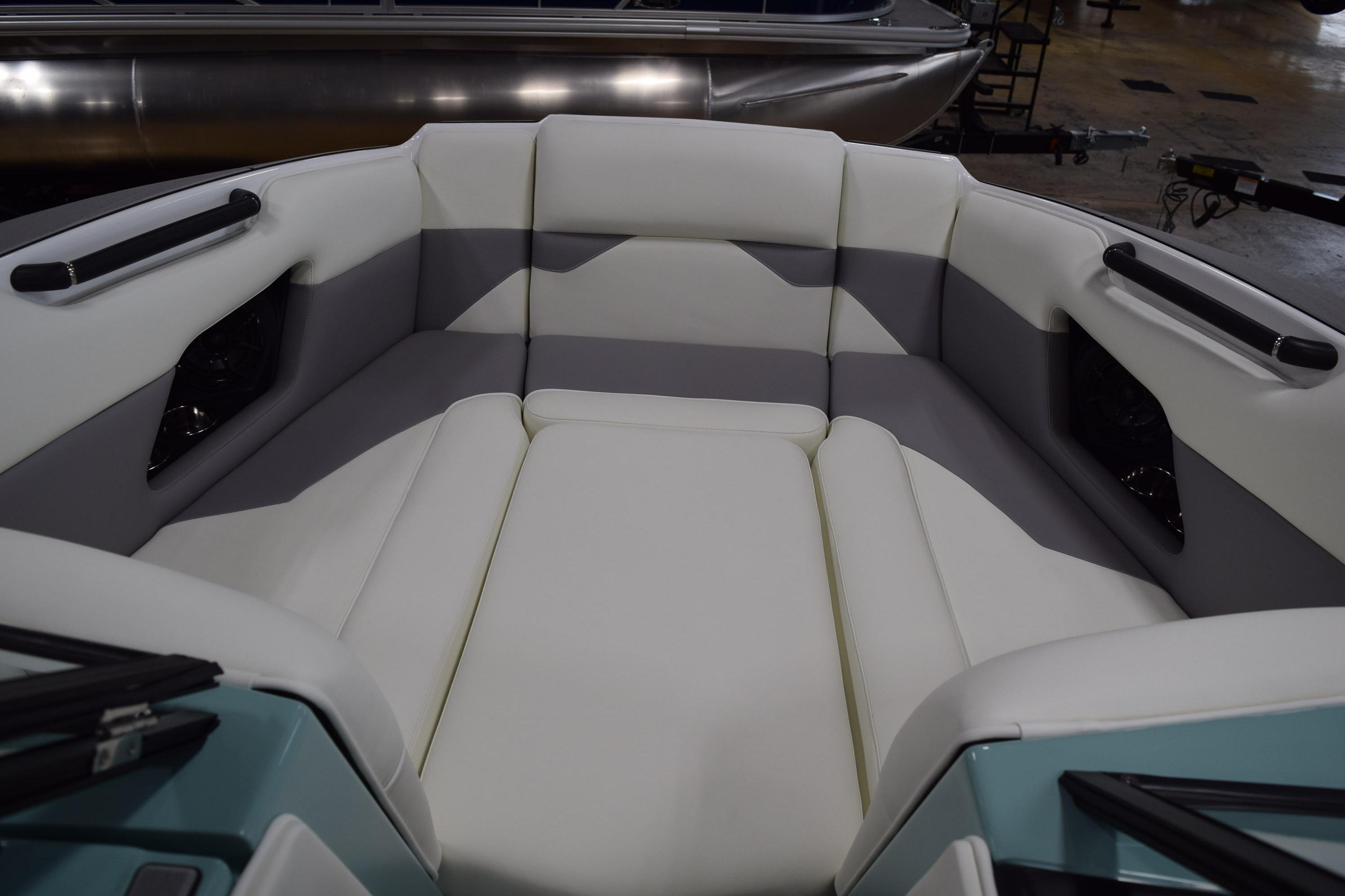 2025 Moomba Mojo boat interior with white and gray seating, showcasing modern design.
