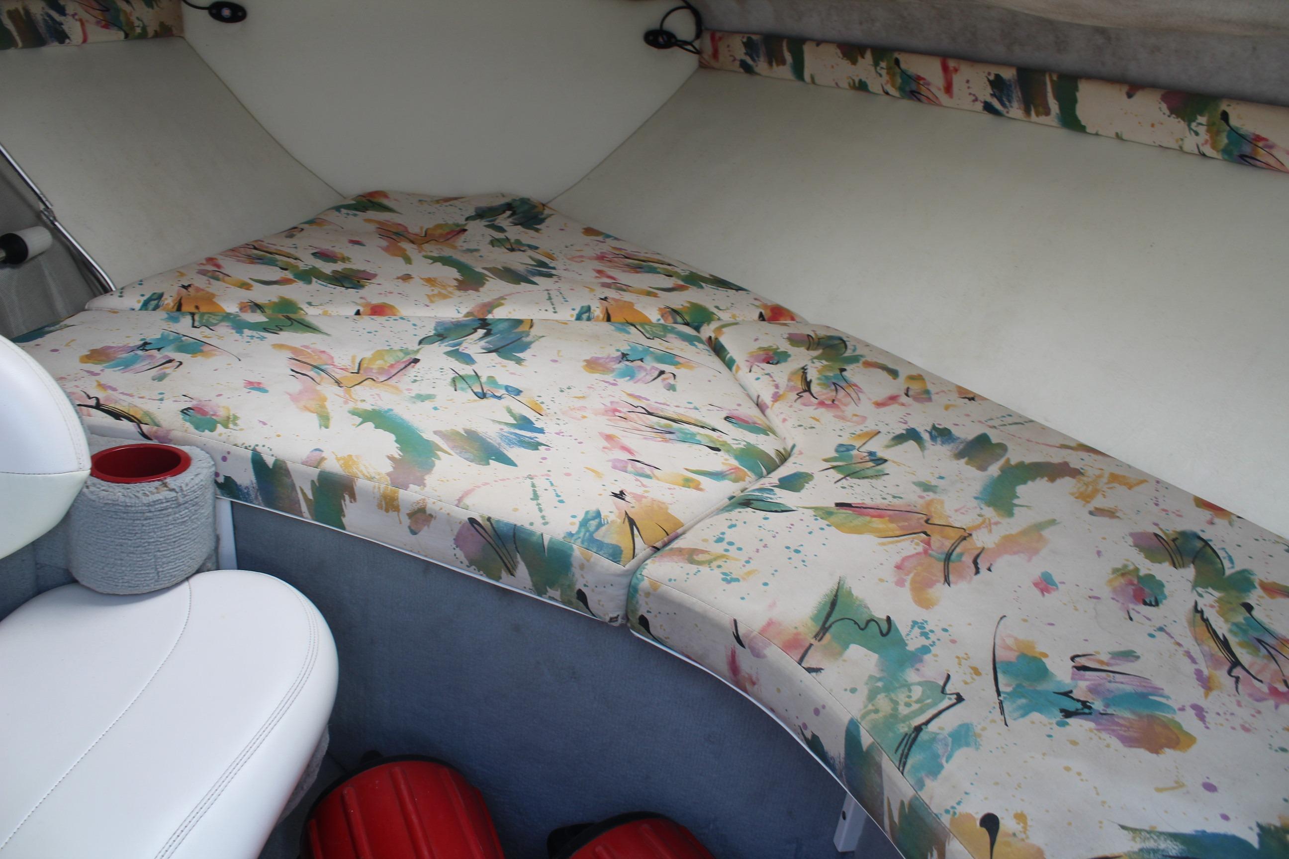 Interior of a 1996 Baja 232 boat with colorful patterned seating.