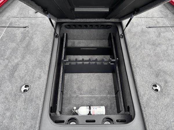 2025 Tracker Savage 215 boat storage compartment with organized interior and fire extinguisher.