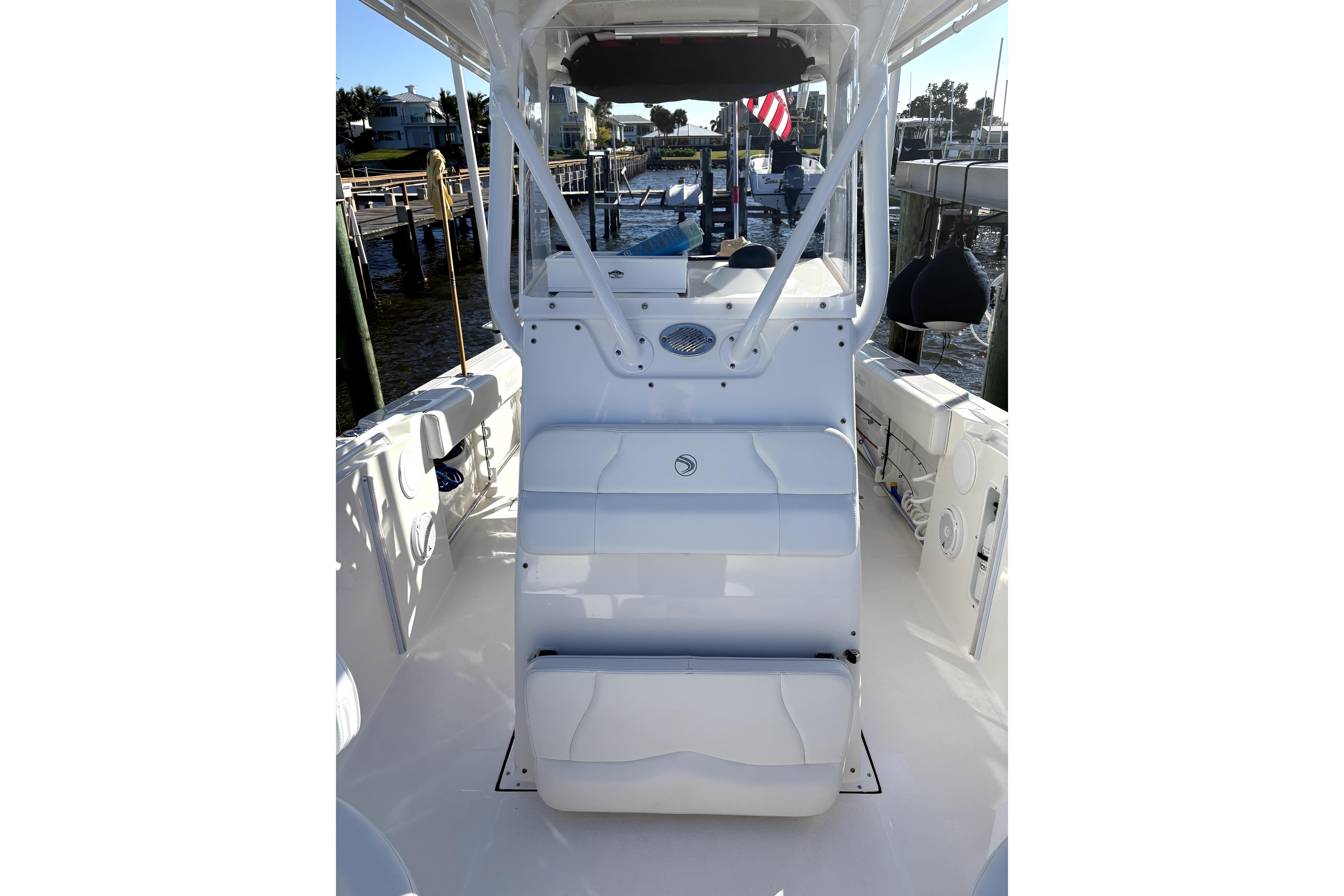 2015 Edgewater 245CC boat interior with seating and helm, docked at marina.