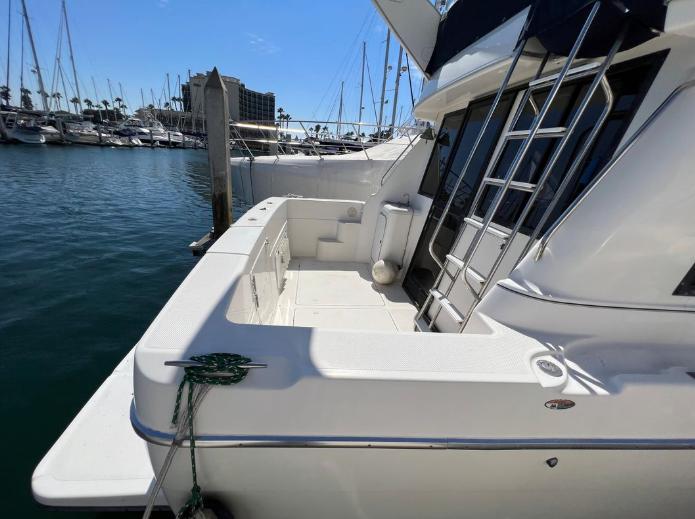 1997 Bayliner 3788 Command Bridge Motoryacht docked at marina, showing spacious deck area.