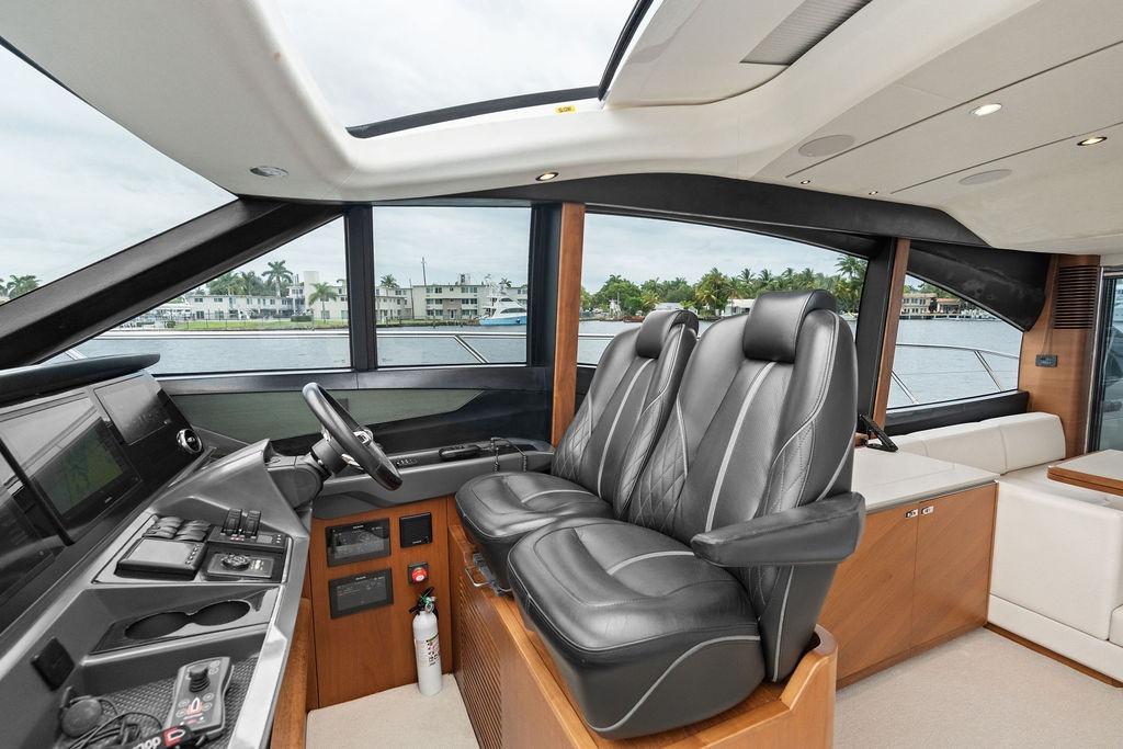 Luxurious interior of 2020 Princess S62 yacht with leather seating and modern controls.