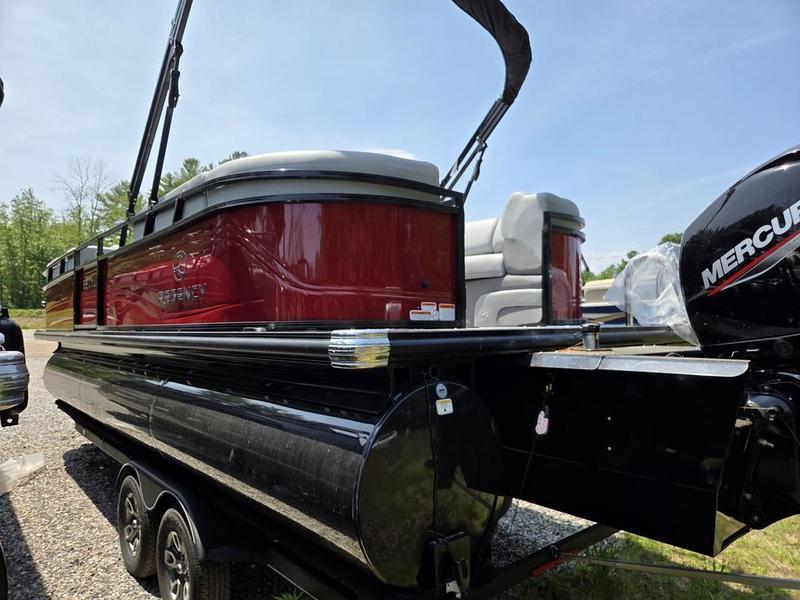 2025 Regency 230 DL3 pontoon boat with Mercury engine, parked on a trailer.
