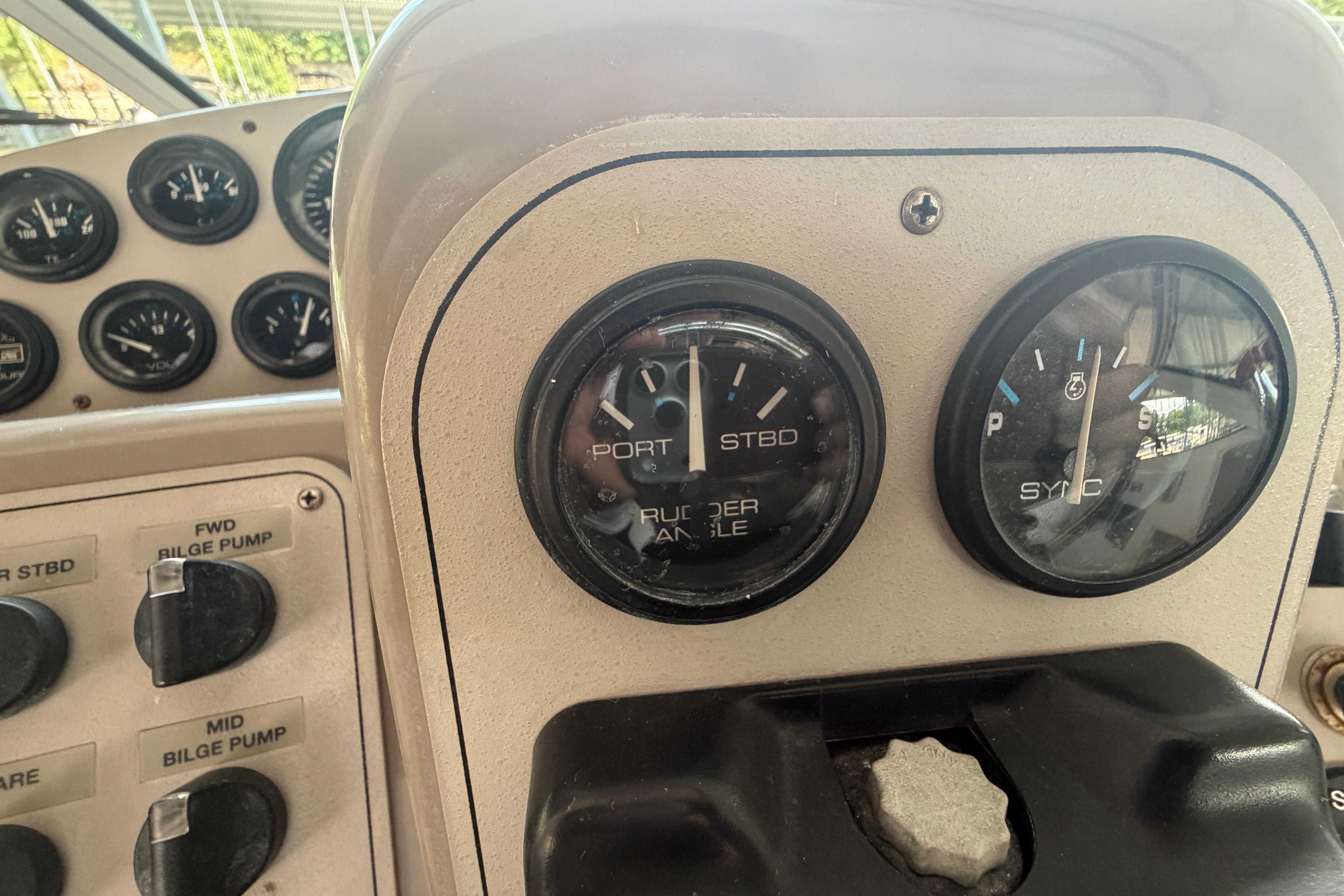 Control panel of a 2000 Carver 350 Mariner boat with gauges and switches.
