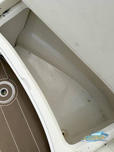 2008 Sea Ray 270 SLX boat interior storage compartment with brown flooring.