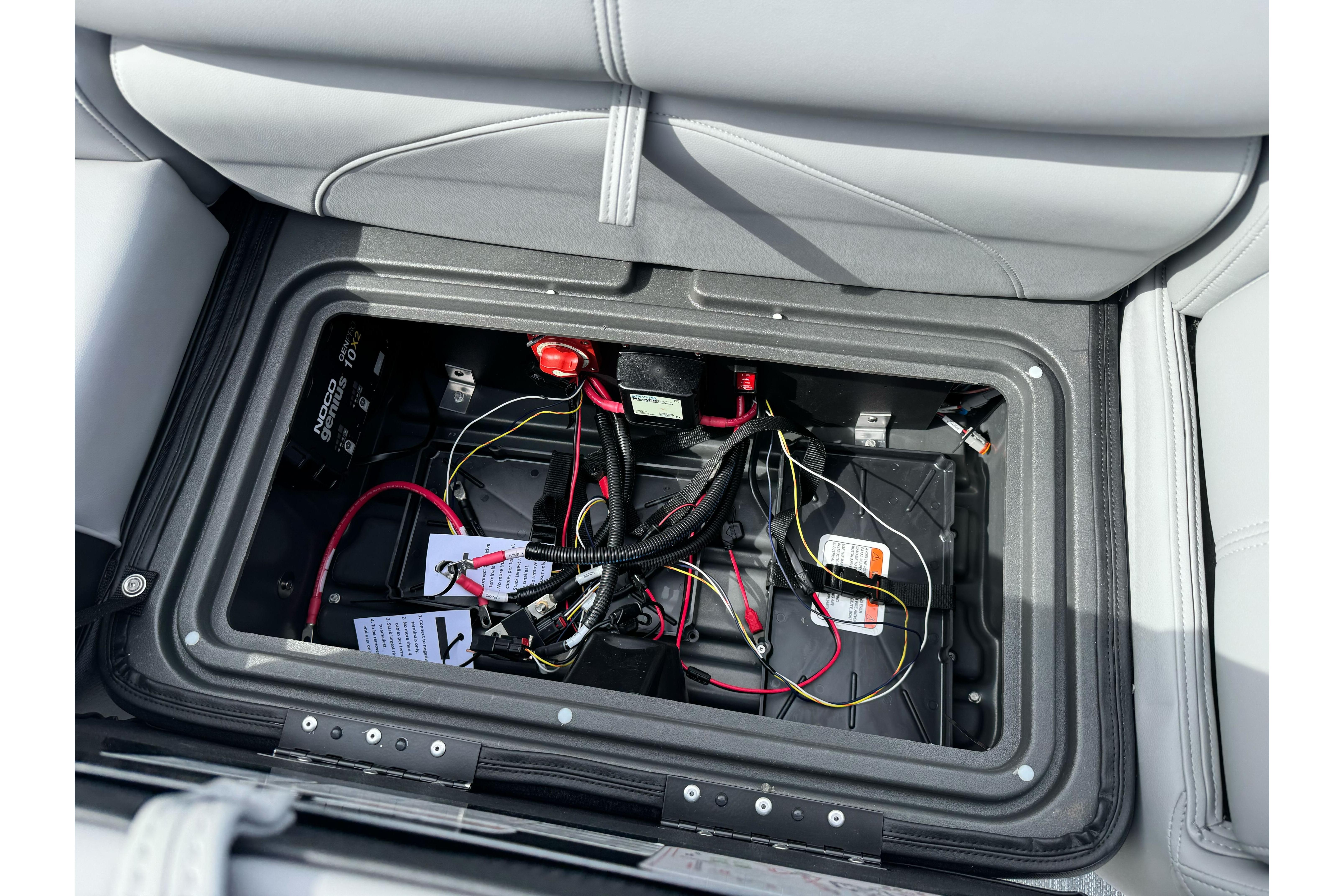 Battery compartment of 2026 Regency 250 DL boat with wiring and components.