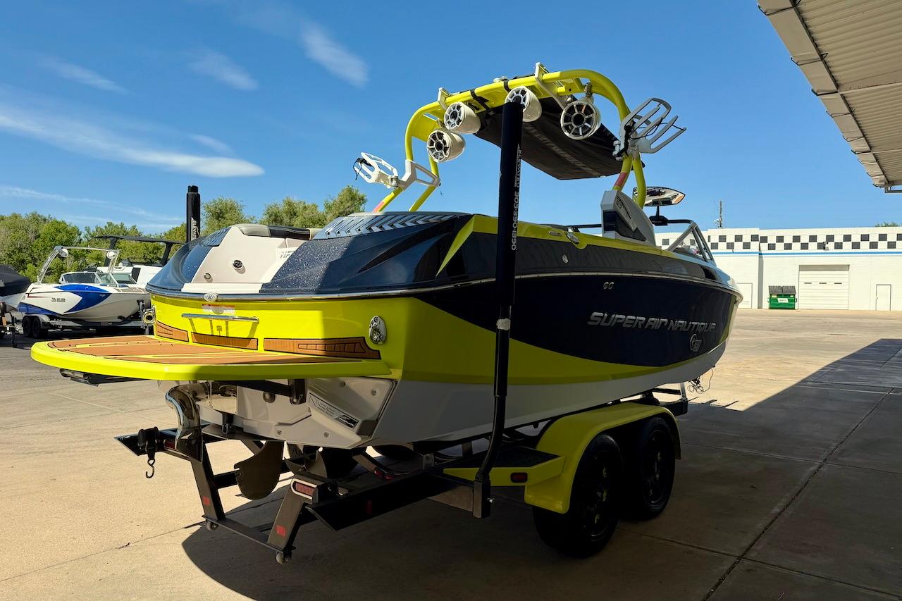 2014 Nautique Super Air Nautique G21 boat on trailer, vibrant yellow and black design.