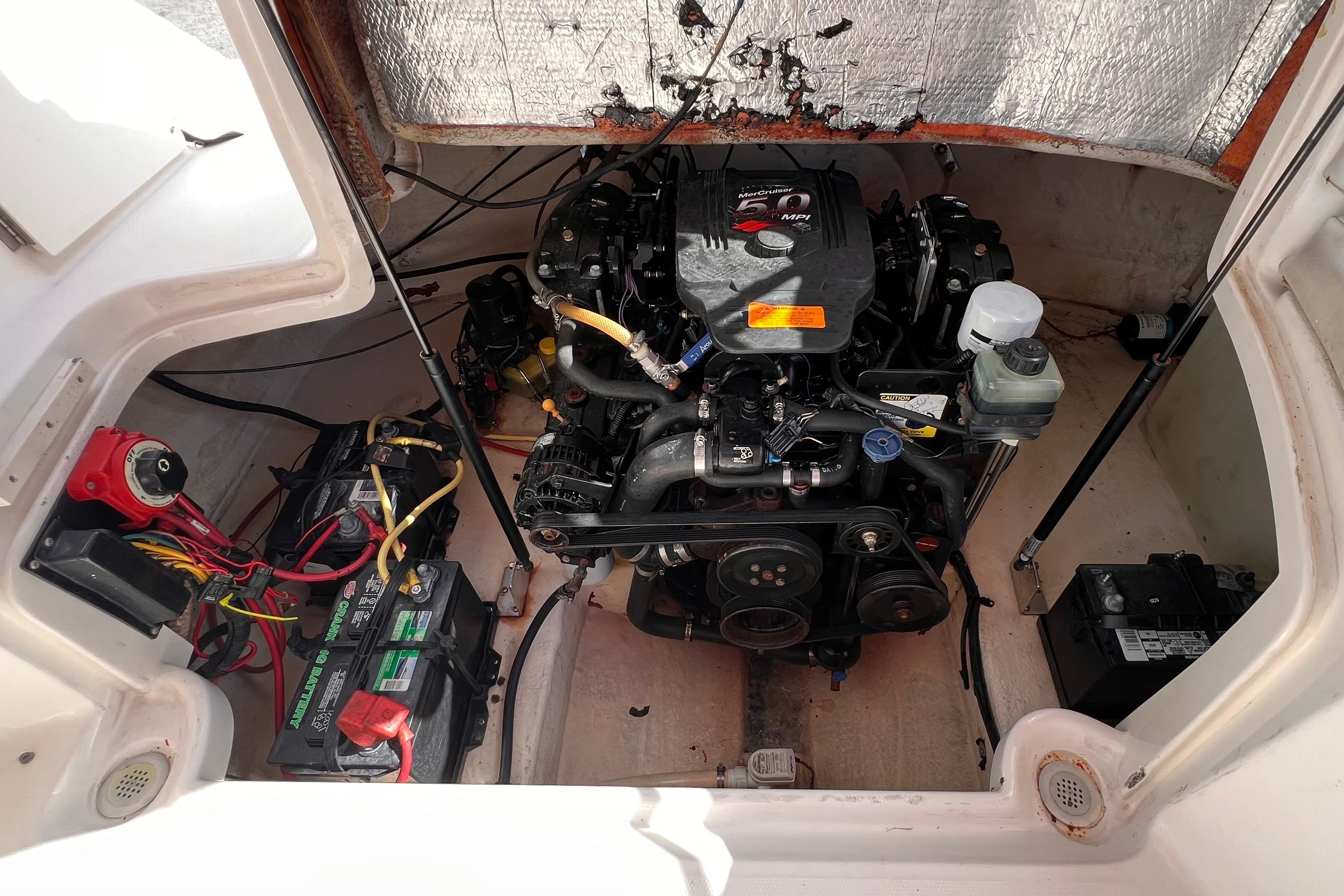 Engine compartment of a 2002 Chaparral 232 Sunesta boat, showing detailed components.