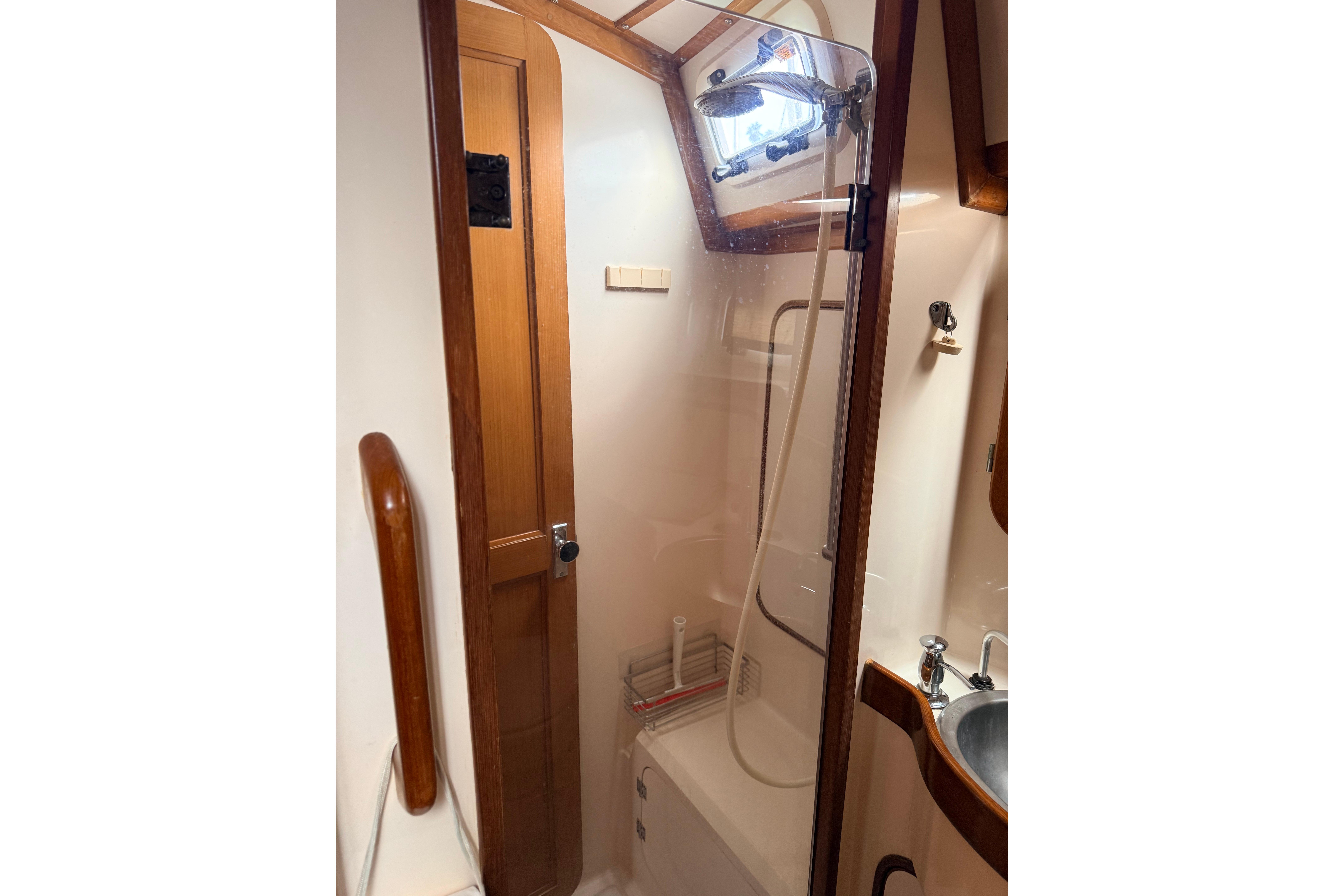 Compact bathroom in 1987 Norseman 400 yacht with shower and sink.