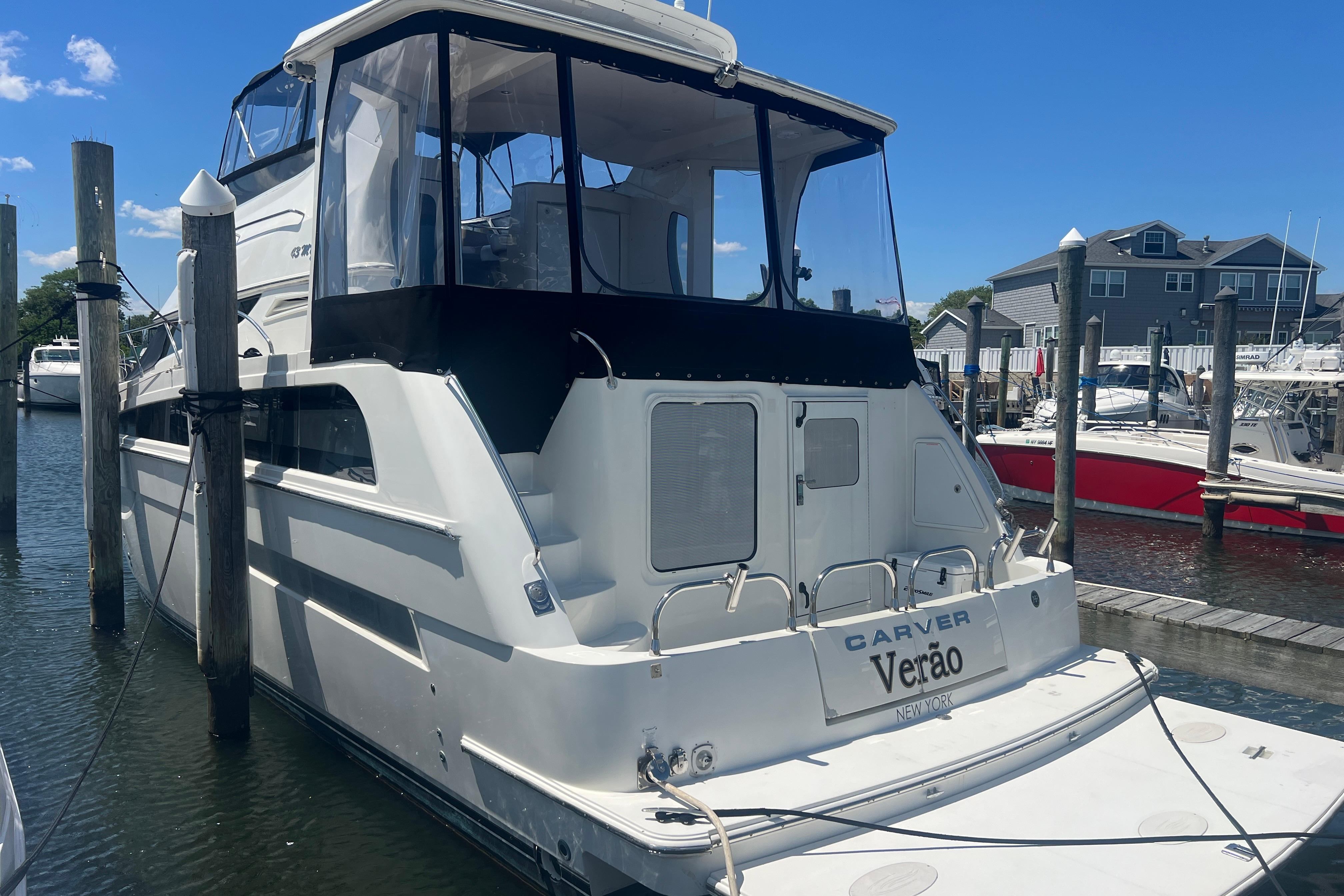 2006 Carver 43 Motor Yacht docked at marina under clear blue sky.