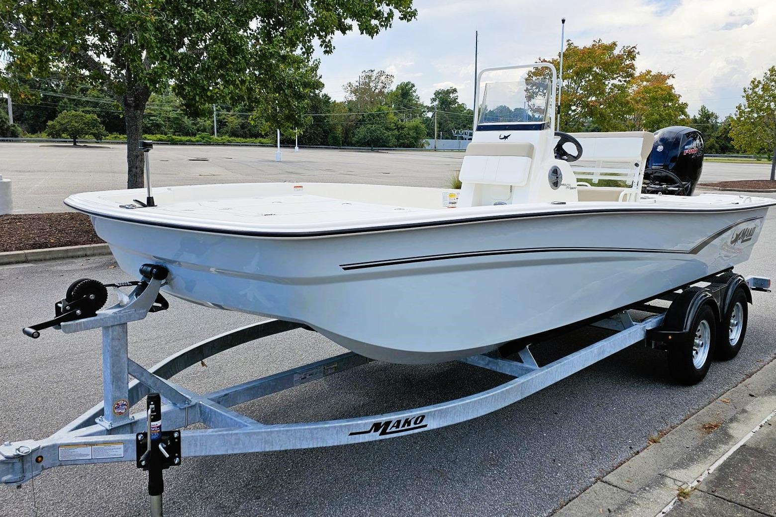2026 Mako Pro Skiff 19 CC boat on trailer in parking lot.
