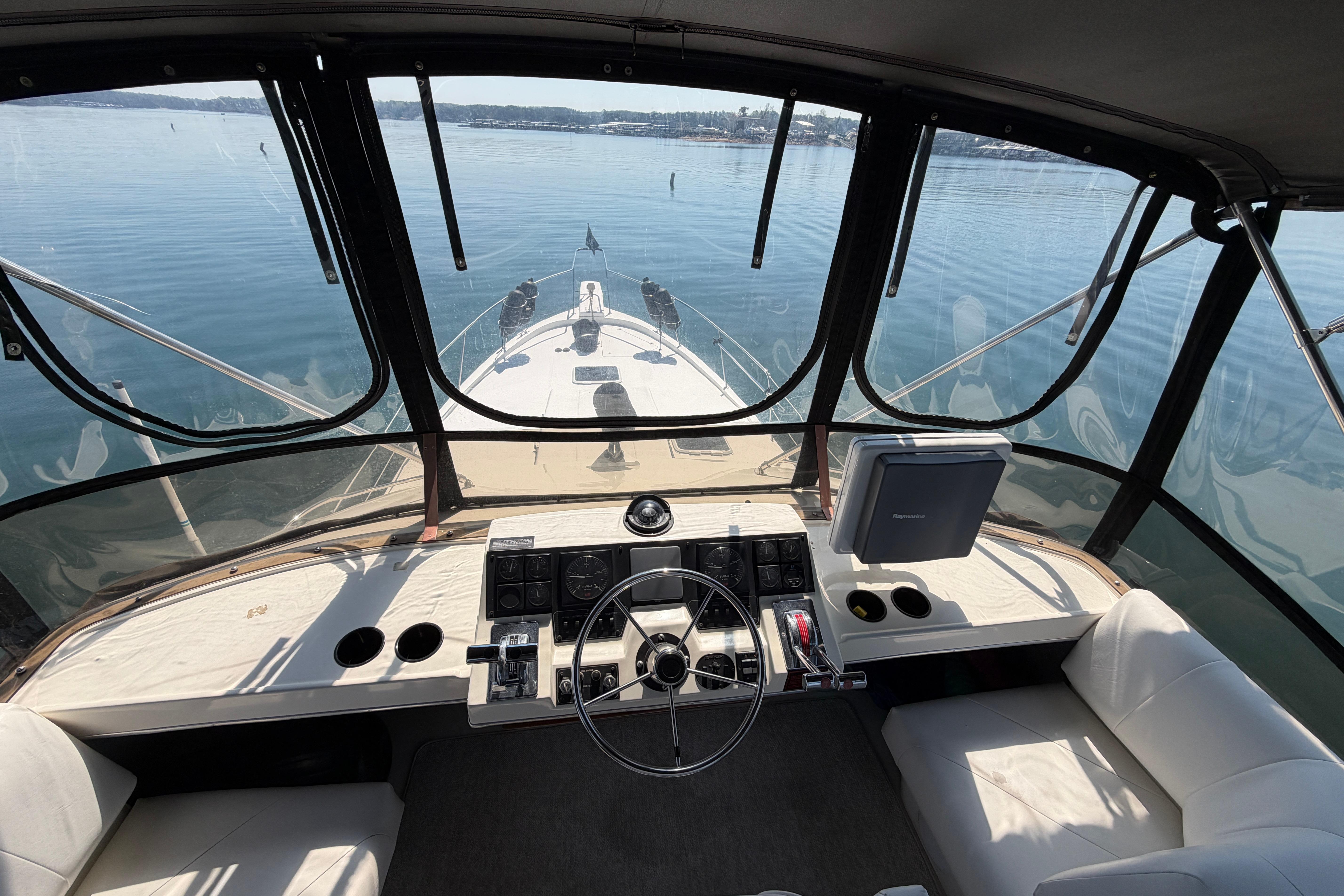 Cockpit view of 1994 Bayliner 3888 MY Sedan yacht on calm water.