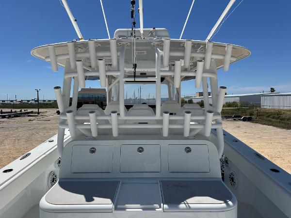 2022 Freeman 42LR boat with rod holders and storage compartments, docked under clear blue sky.