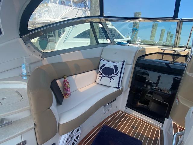 Interior of 2014 Four Winns 355V boat with cushioned seating and nautical decor.