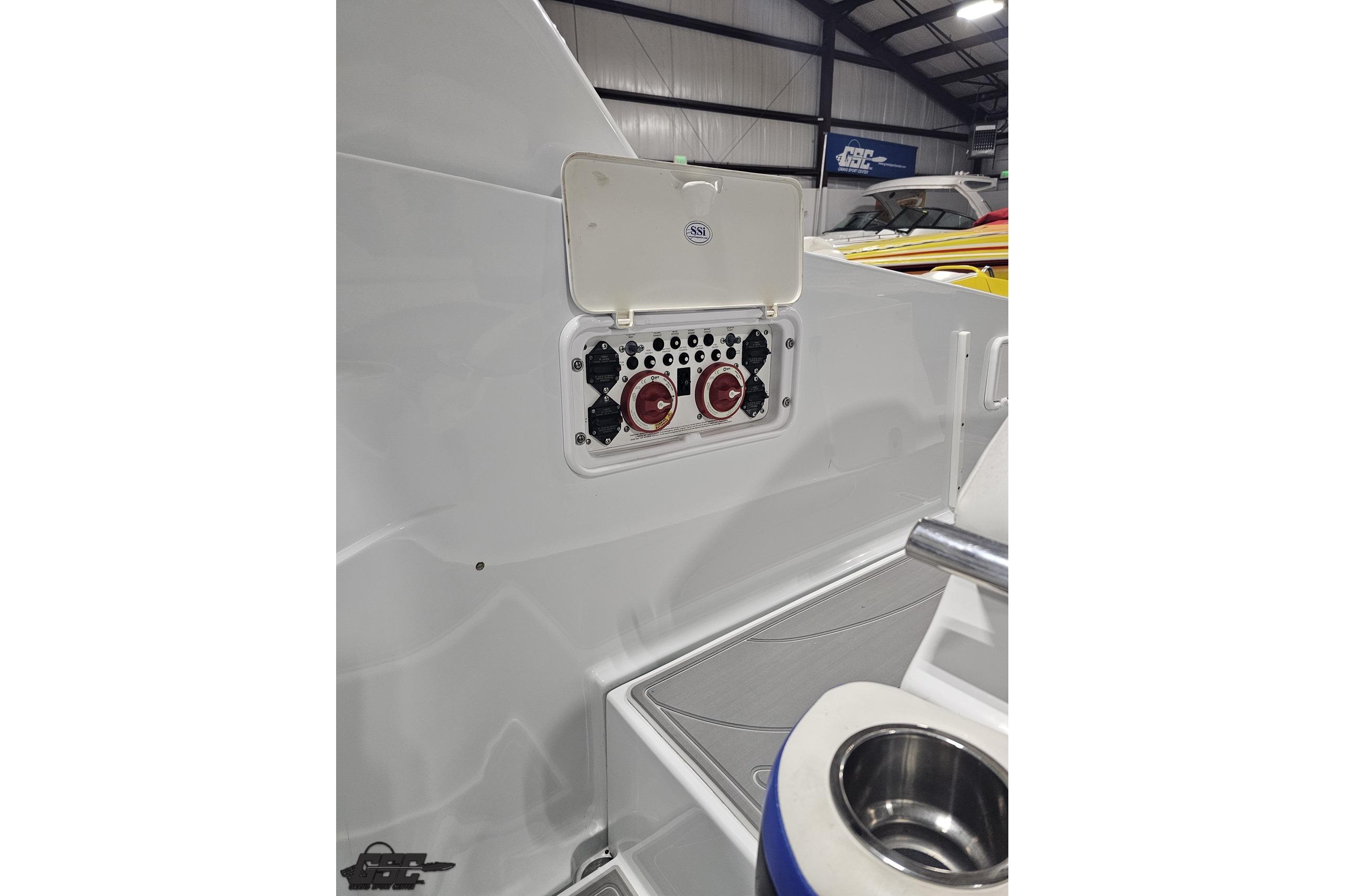 Control panel on a 2008 Baja 335 Performance boat, featuring switches and dials.
