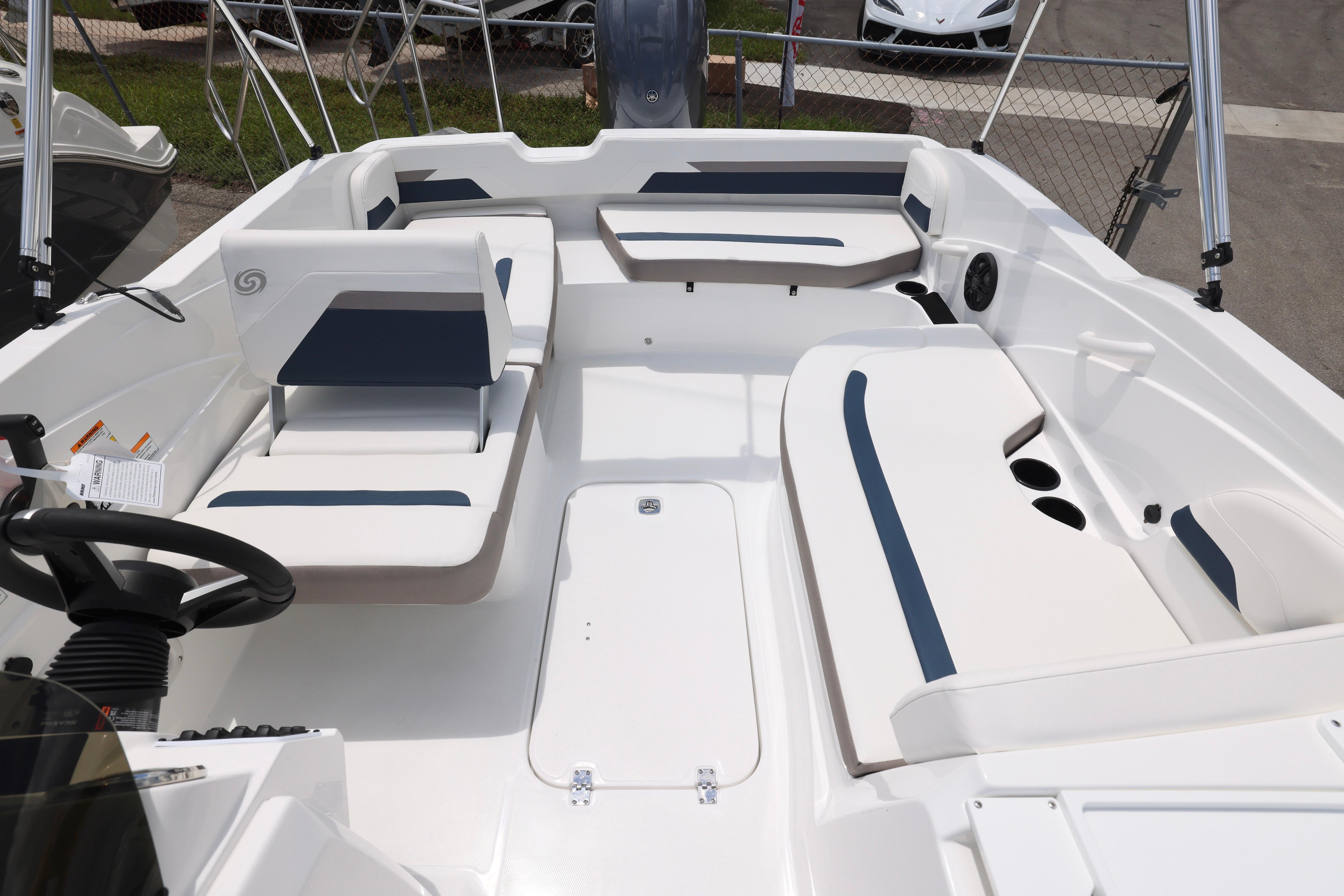 2026 Hurricane SunDeck Sport 205 OB boat interior with seating and steering wheel.