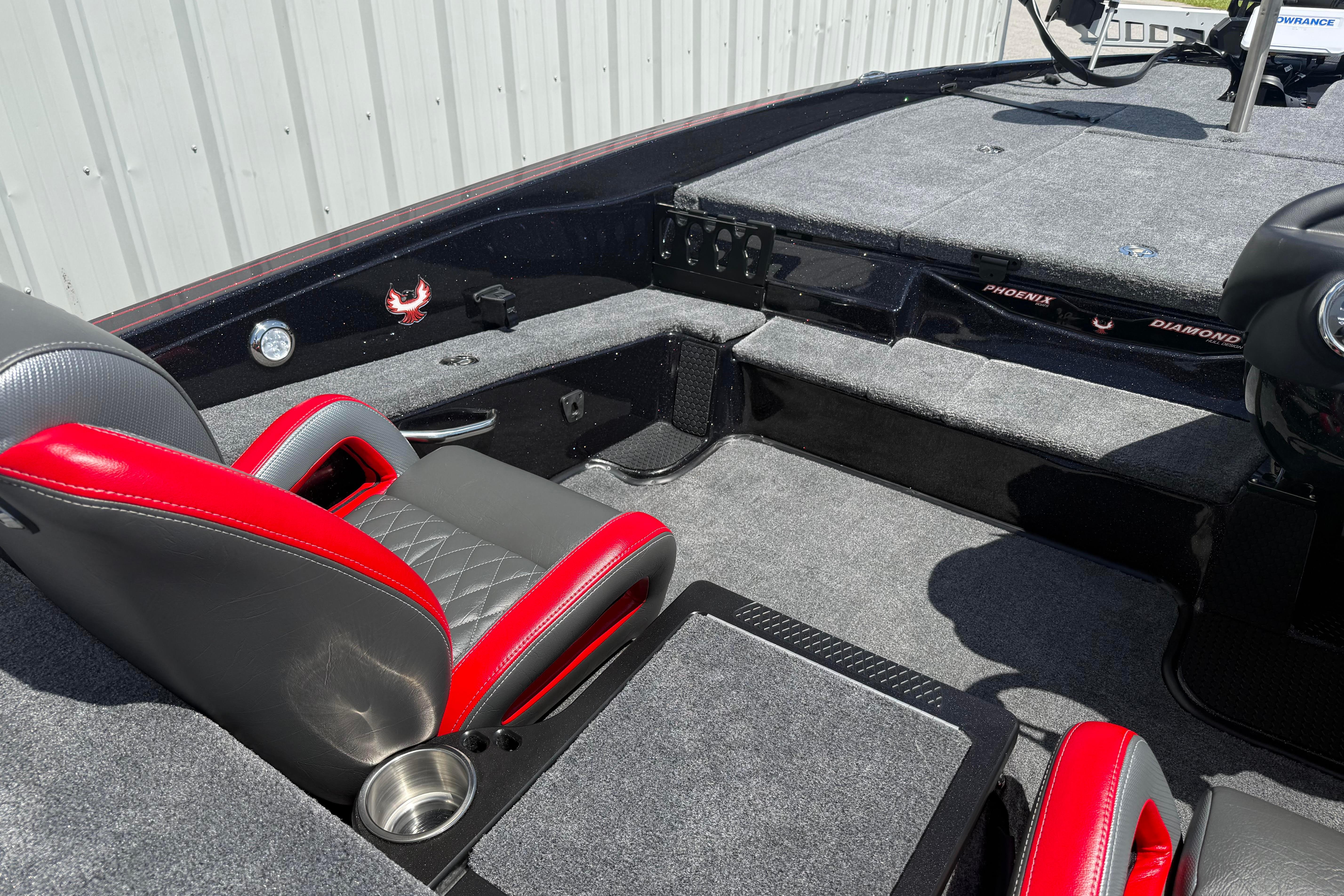 Interior of 2027 Phoenix 919 ZXL boat with red and gray seating, carpeted deck.