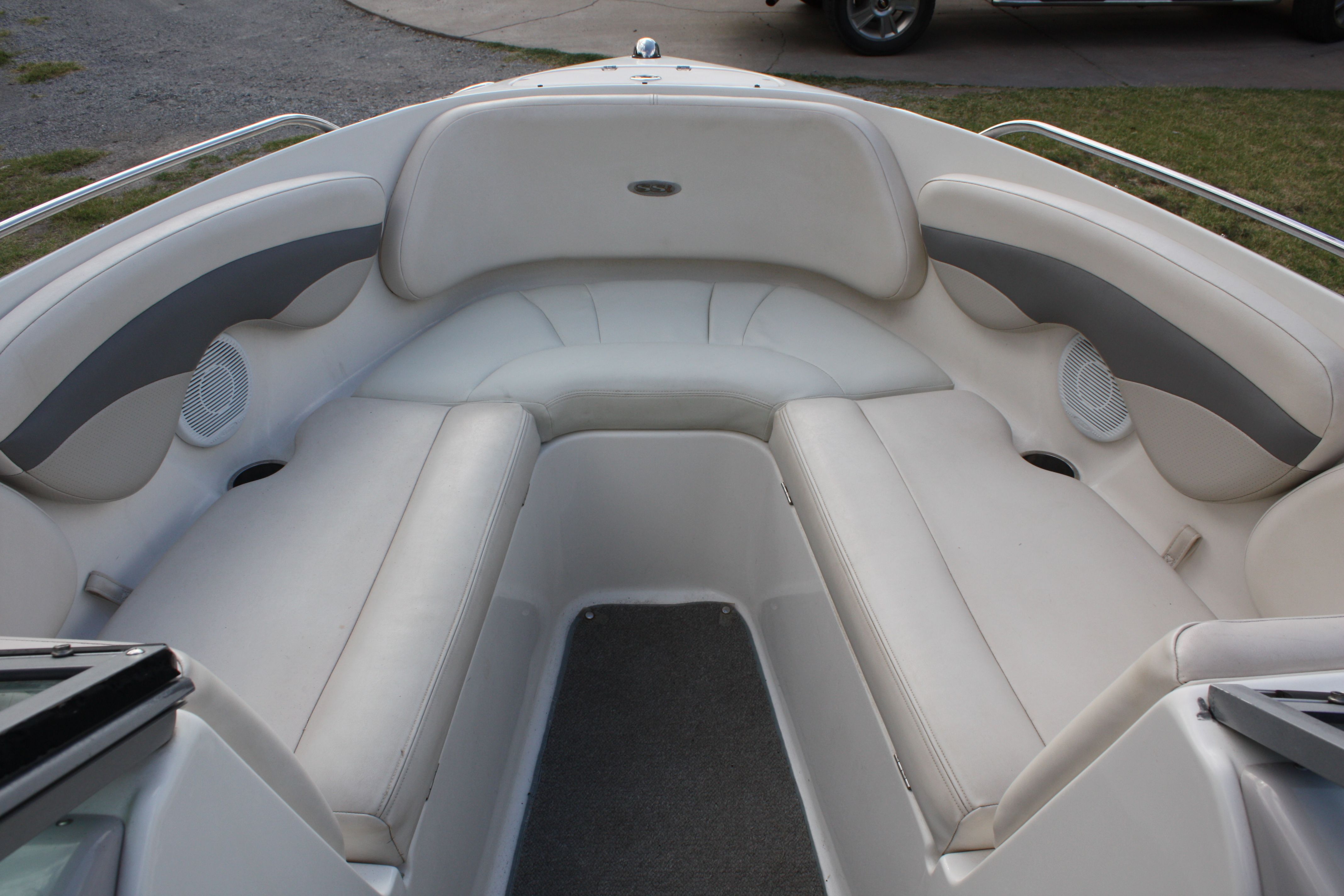 The image shows the bow area of a Chaparral 210 SSi boat with white cushioned seating.