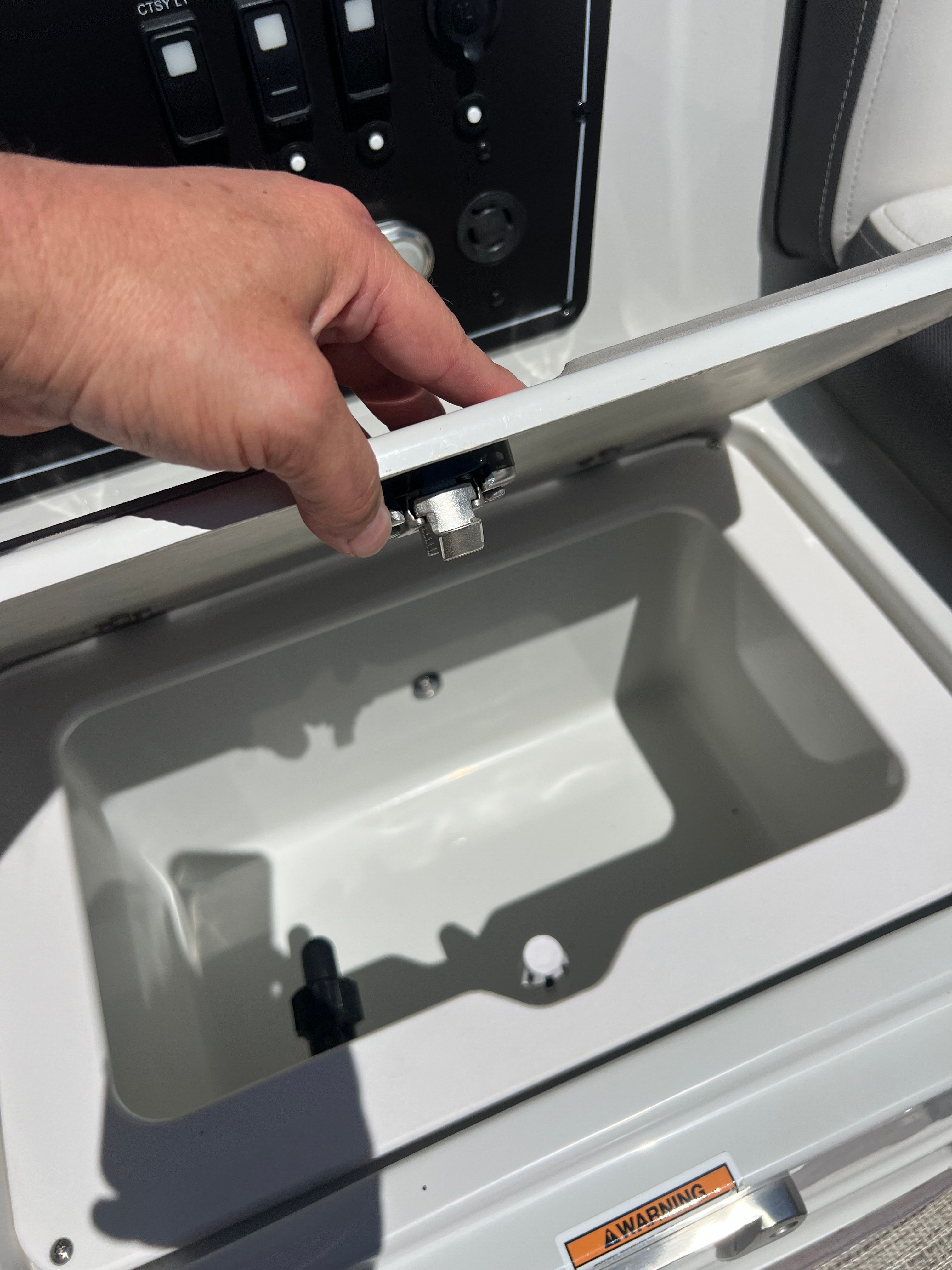 2024 Crownline Eclipse E210 XS boat compartment with hand opening.