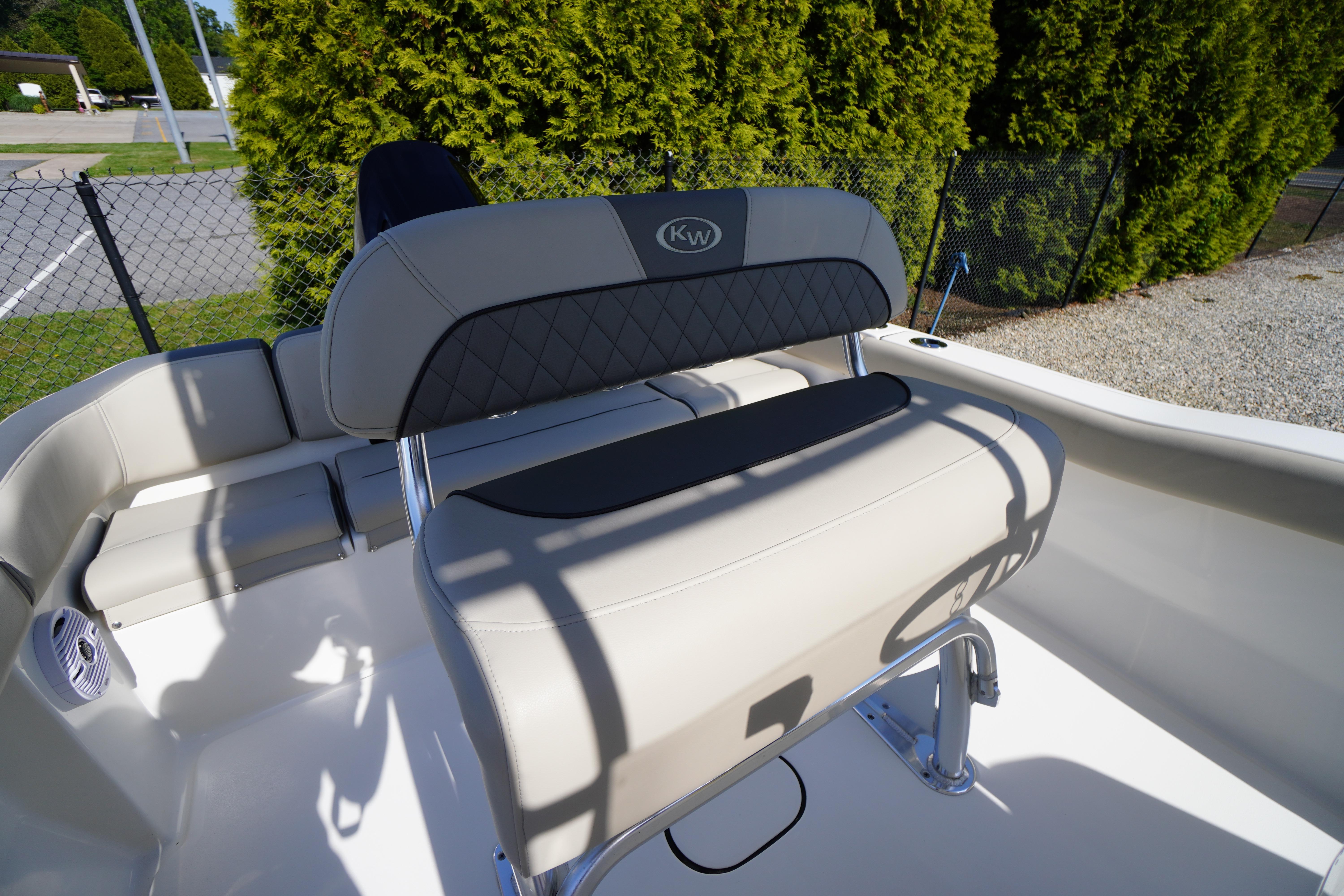 2025 Key West 203 FS boat interior with beige seating and stainless steel fixtures.