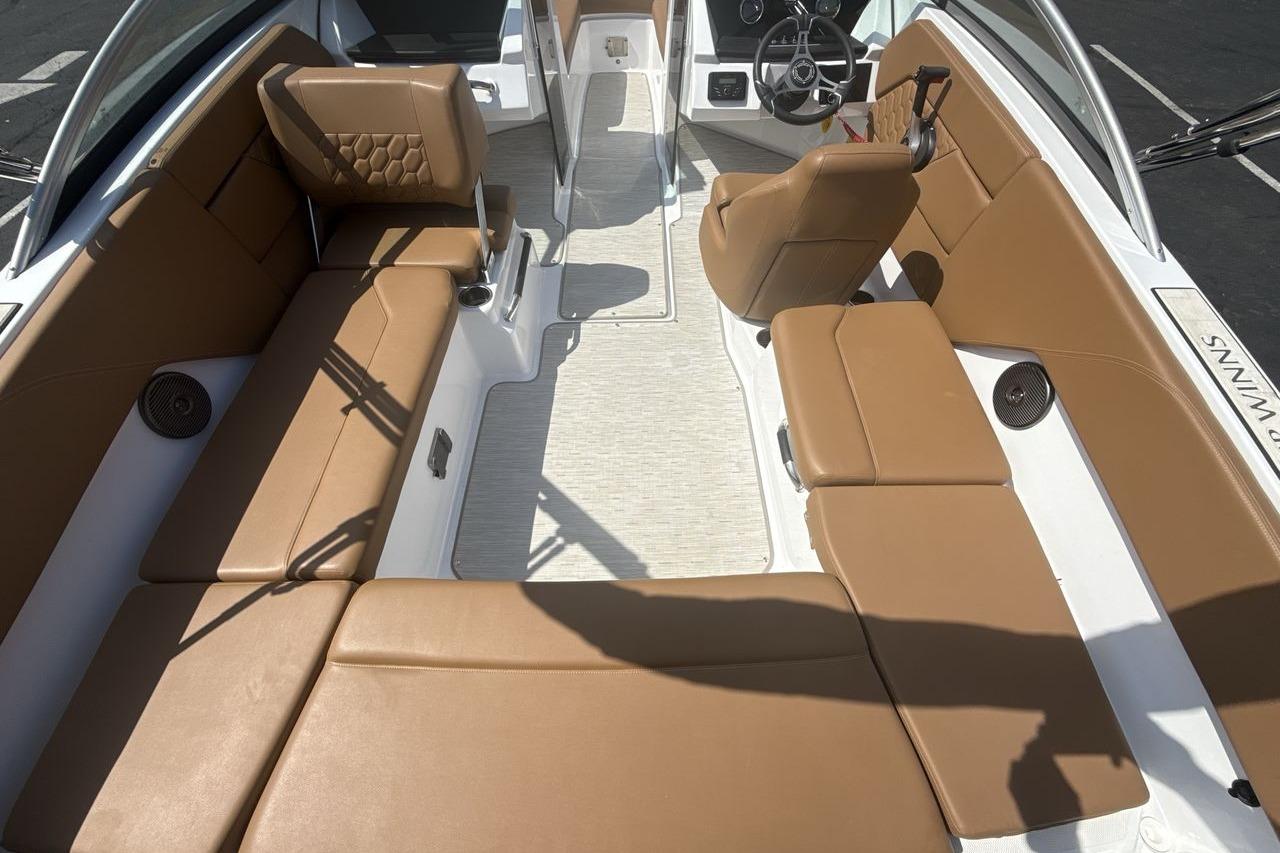 2024 Four Winns H1 OB boat interior with tan seating and modern steering console.