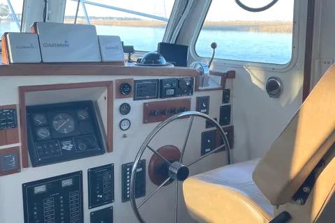 1997 Rosborough Trawler helm with navigation instruments and steering wheel.