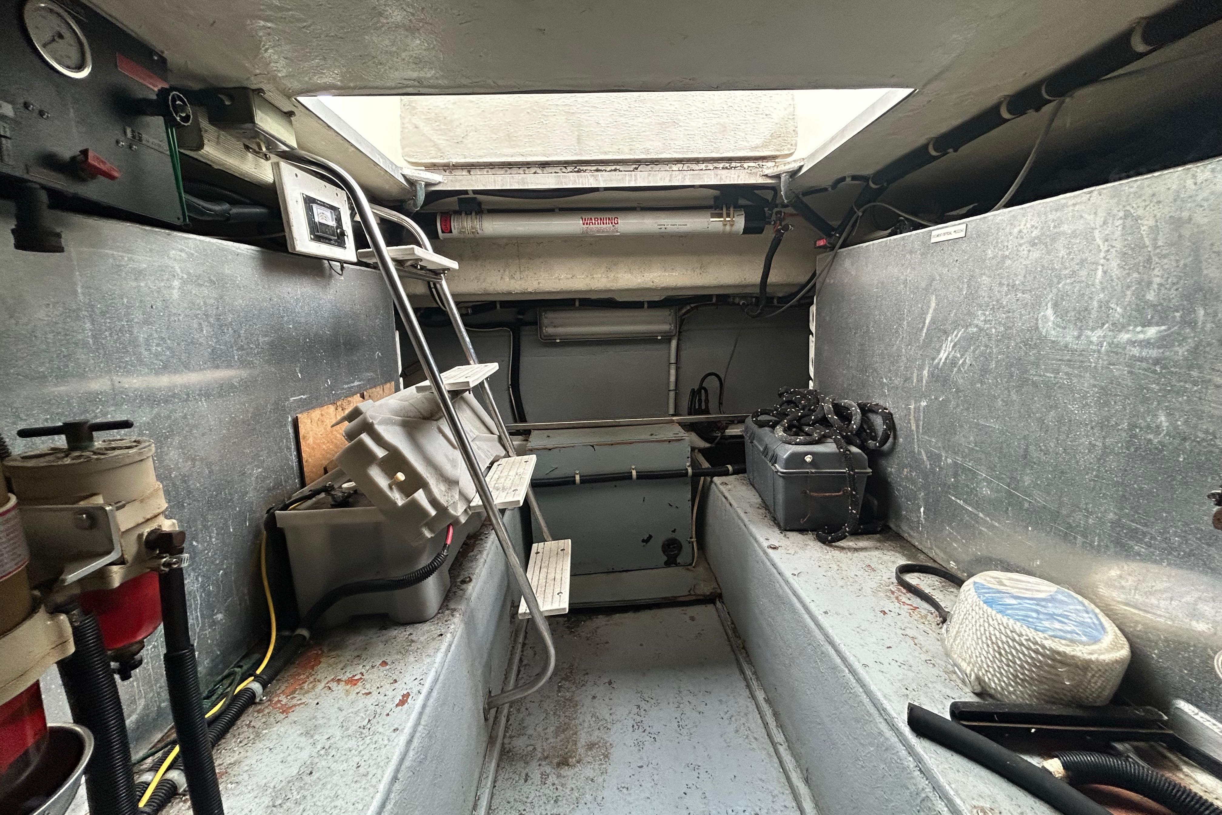 Engine room of a 1996 Navigator 53 Classic yacht, featuring equipment and storage.