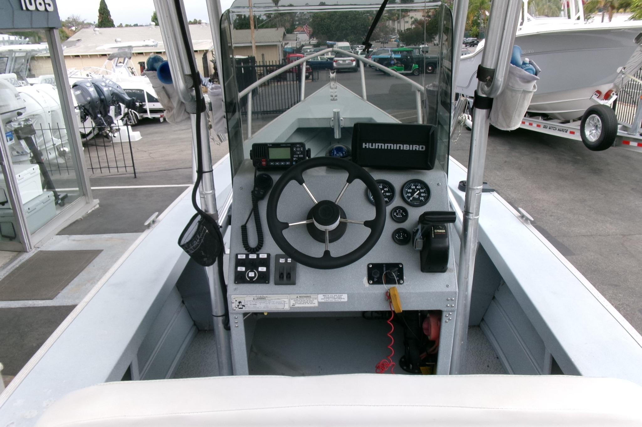 2017 Klamath Bayrunner 19 Baja boat dashboard with steering wheel and navigation equipment.